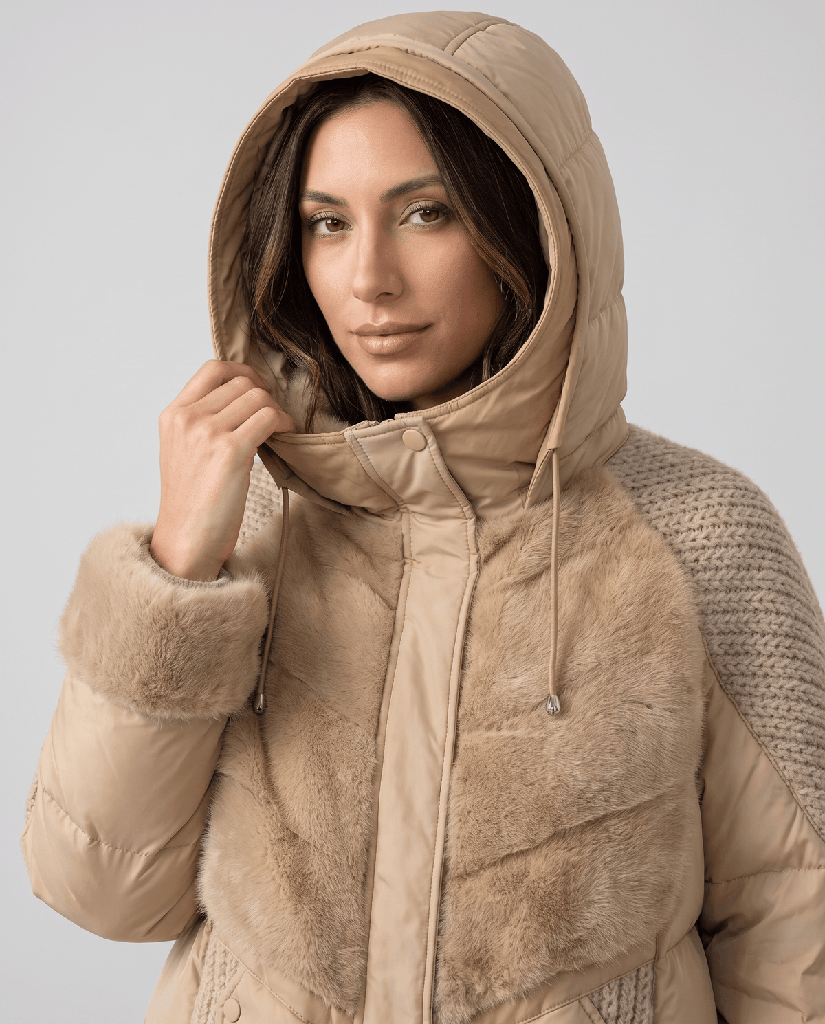 Model wearing the drawstring hood up on a khaki quilted jacket