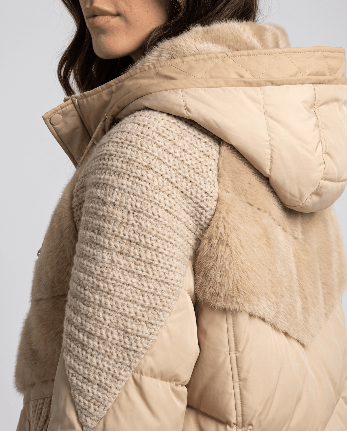 Close-up of the textured knit shoulder panel and plush yoke on a khaki jacket