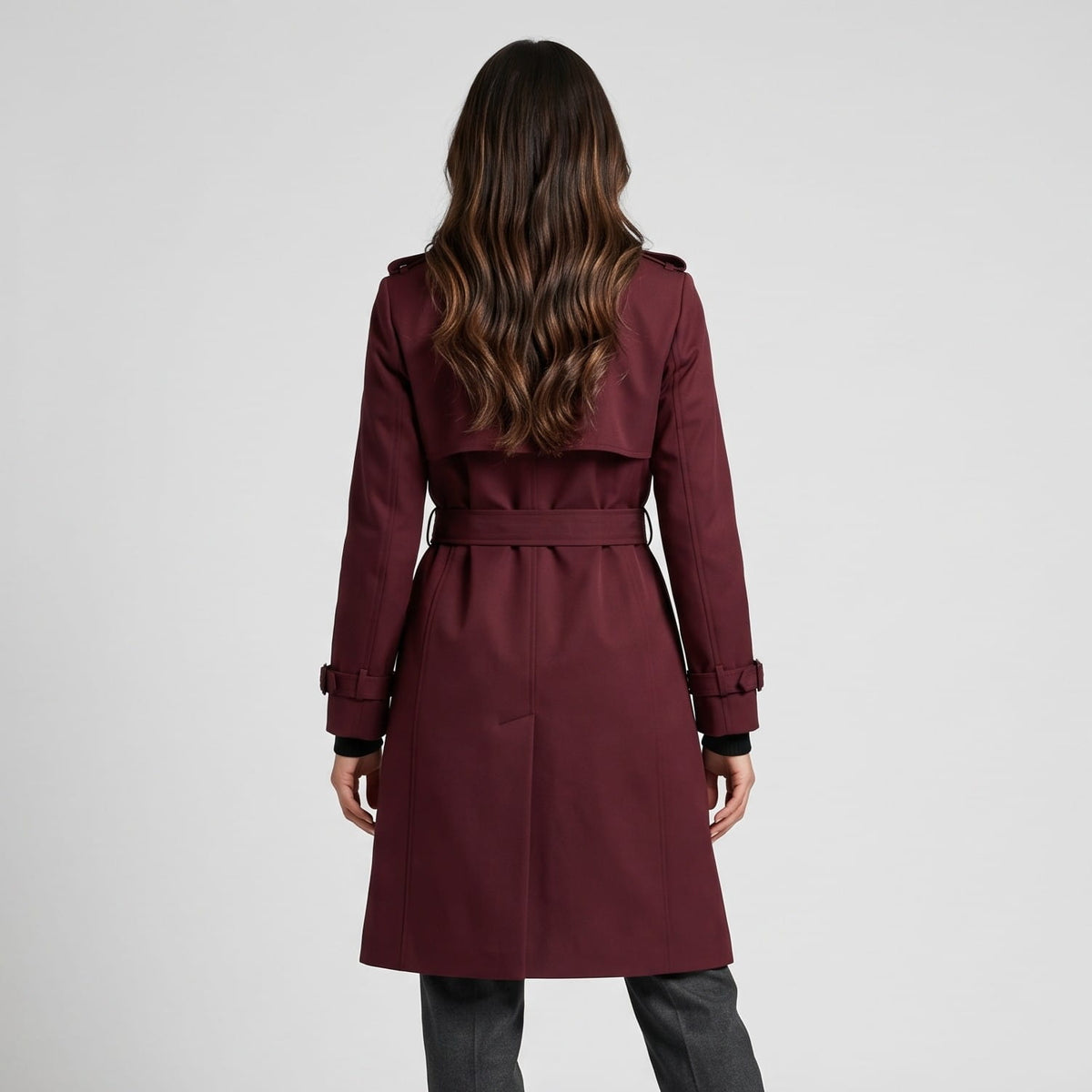 Back view of burgundy coat with back storm flap and belted waist