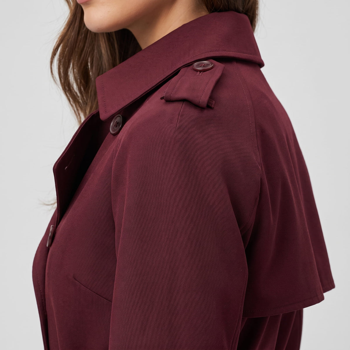 Shoulder detail showing the buttoned epaulette, collar and storm flap