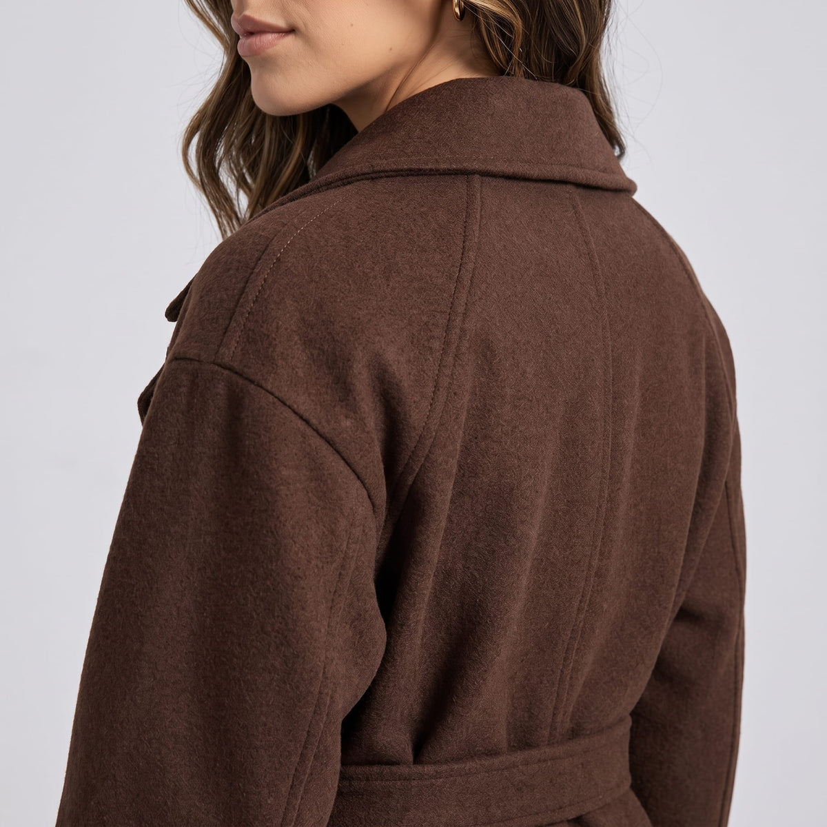 Rear shoulder detail of brown coat showing the collar and fabric texture