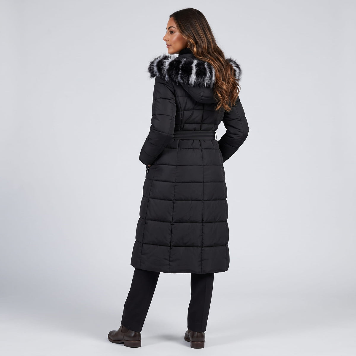 Rear view of black coat showing the hood trim and long quilted length
