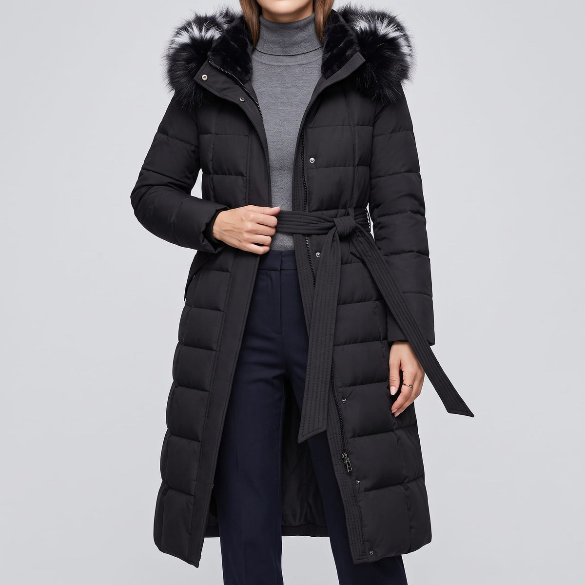 Black coat worn over a gray turtleneck with the belt tied