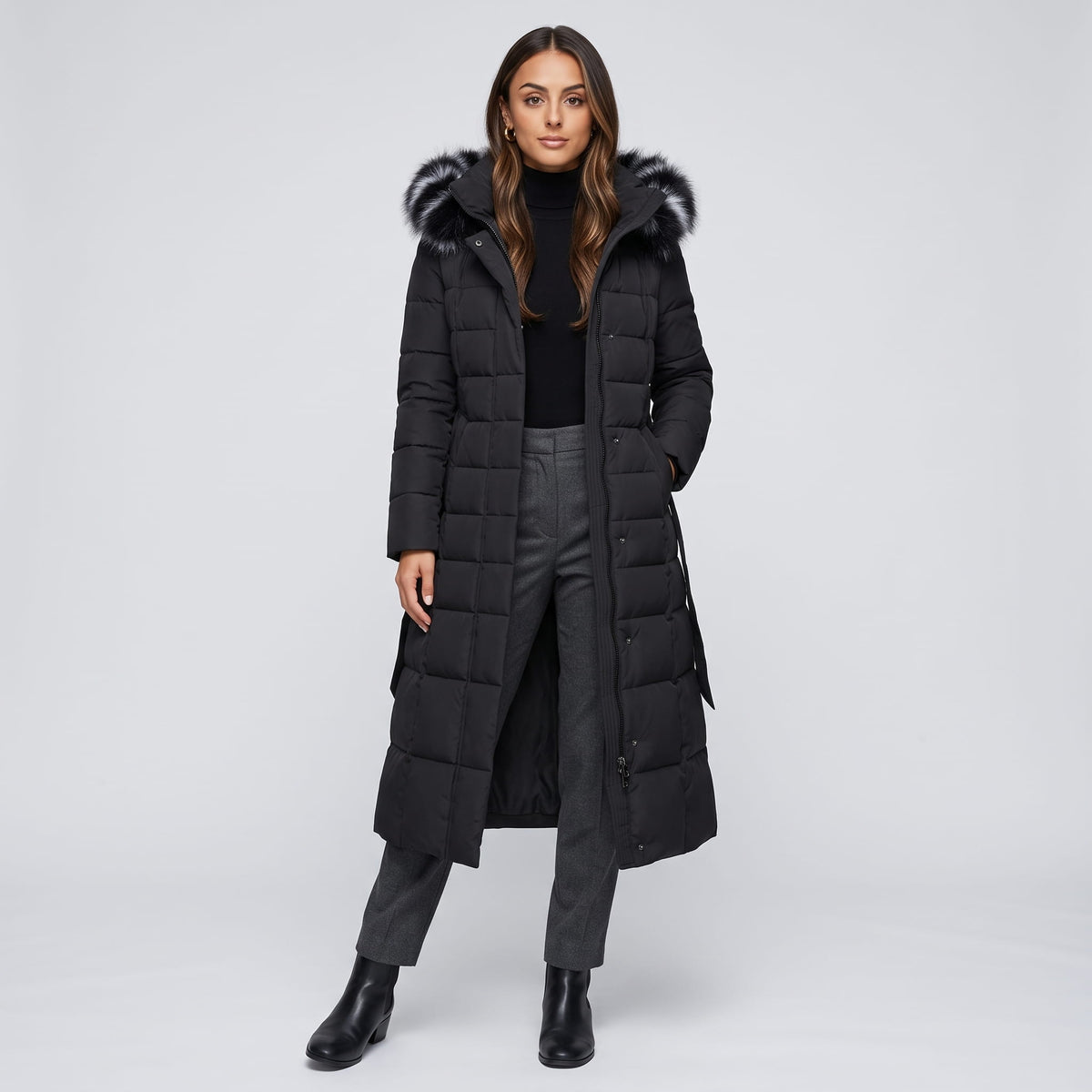 Full-length view of black puffer coat with plush trim hood, worn open