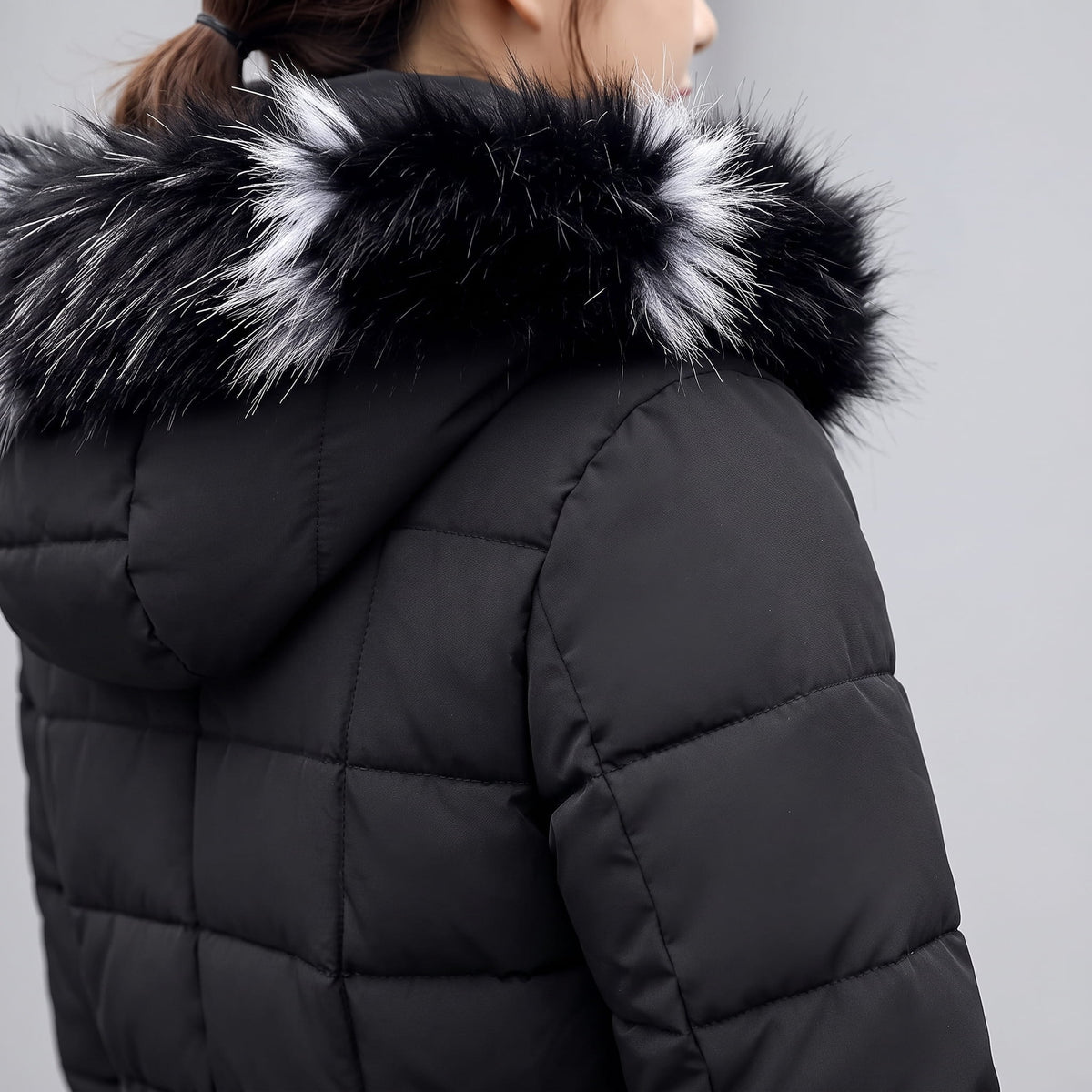 Close-up of black and white plush trim on a black coat hood