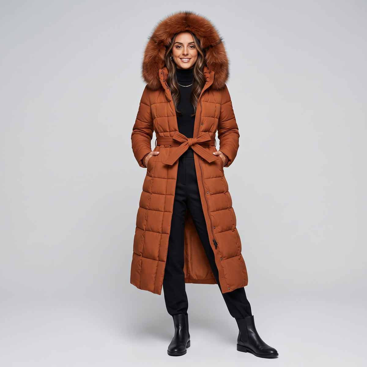 Full-length view of caramel coat with plush-trimmed hood and tie belt