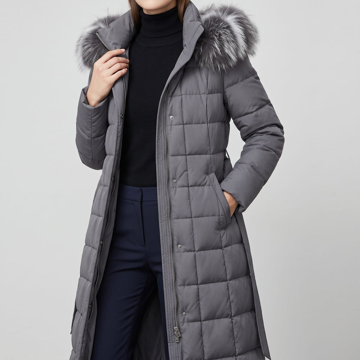 Gray coat worn open over a black turtleneck, hood trim at the collar