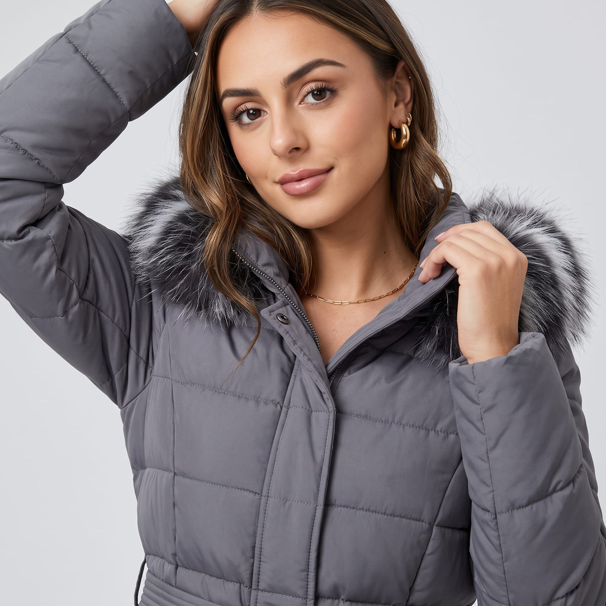 Close-up of the plush trim hood on a gray quilted coat