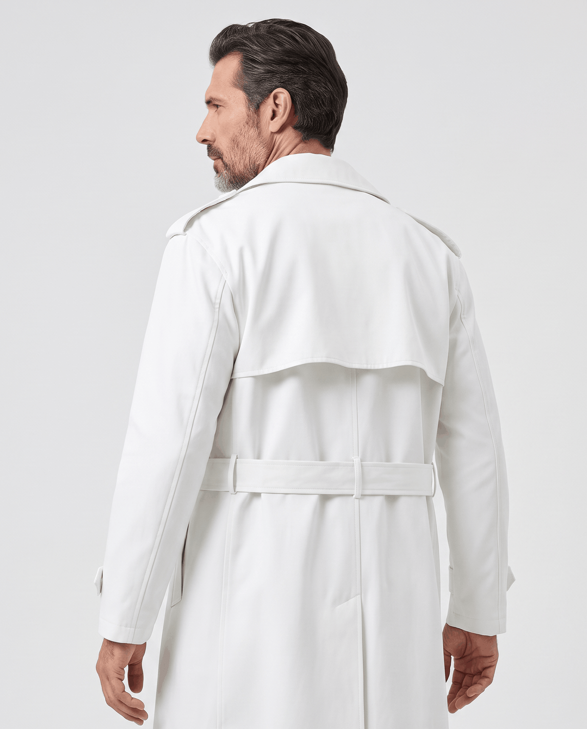 Back view of white trench coat showing storm yoke, epaulets and belted waist