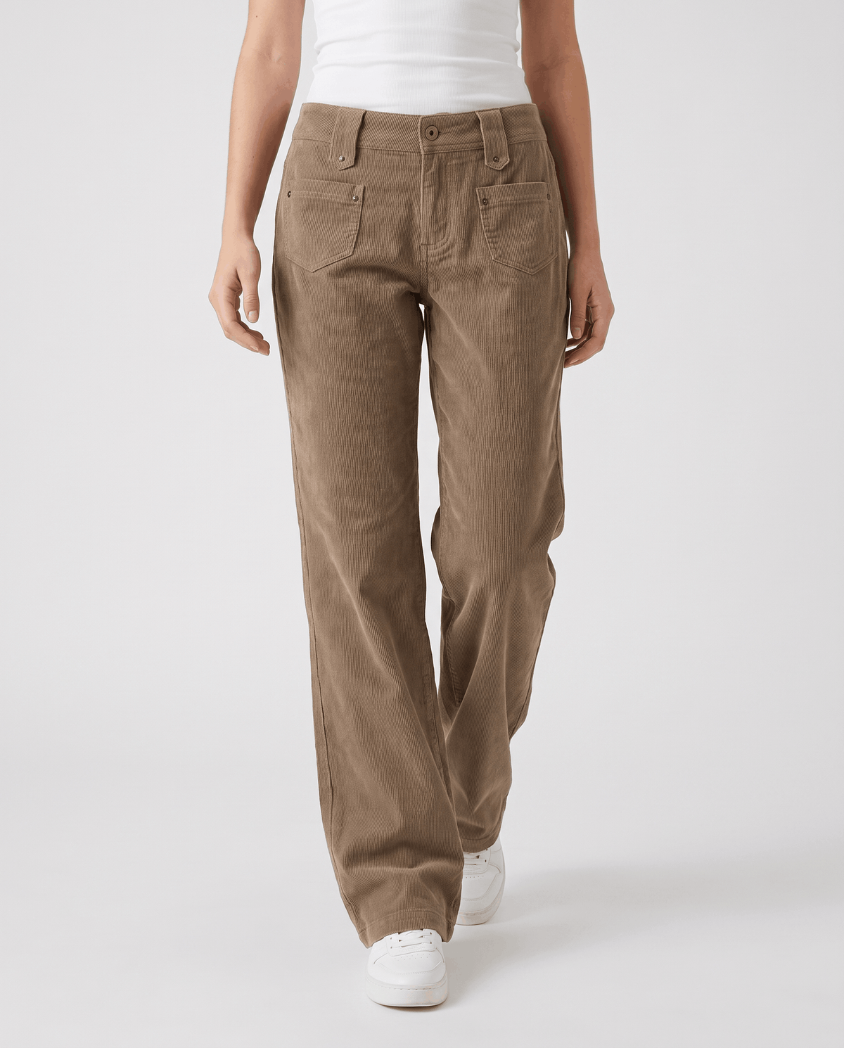 Angled front view of khaki ribbed trousers with front patch pockets and white sneakers