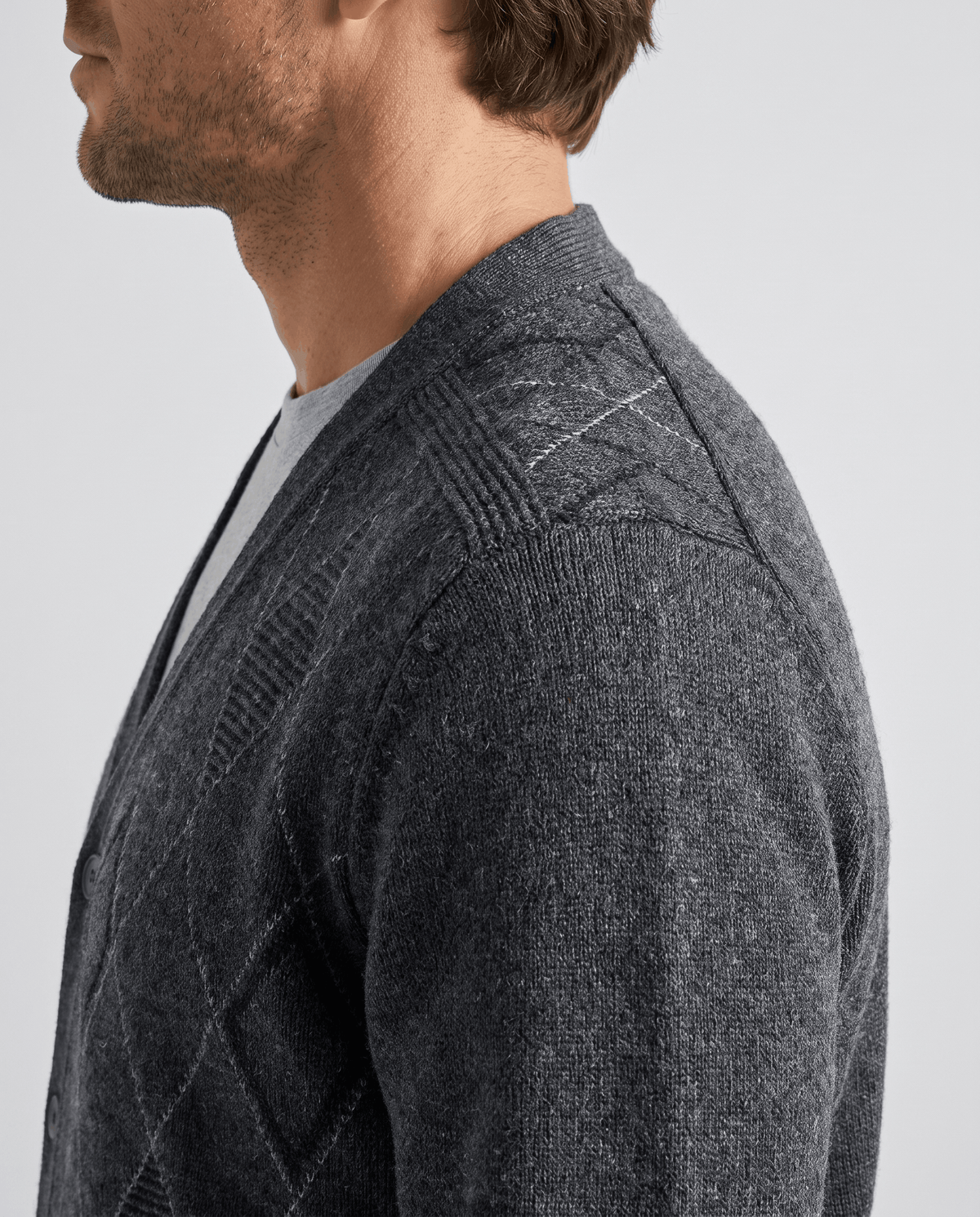 Side profile of the dark gray knit showing argyle texture across the shoulder