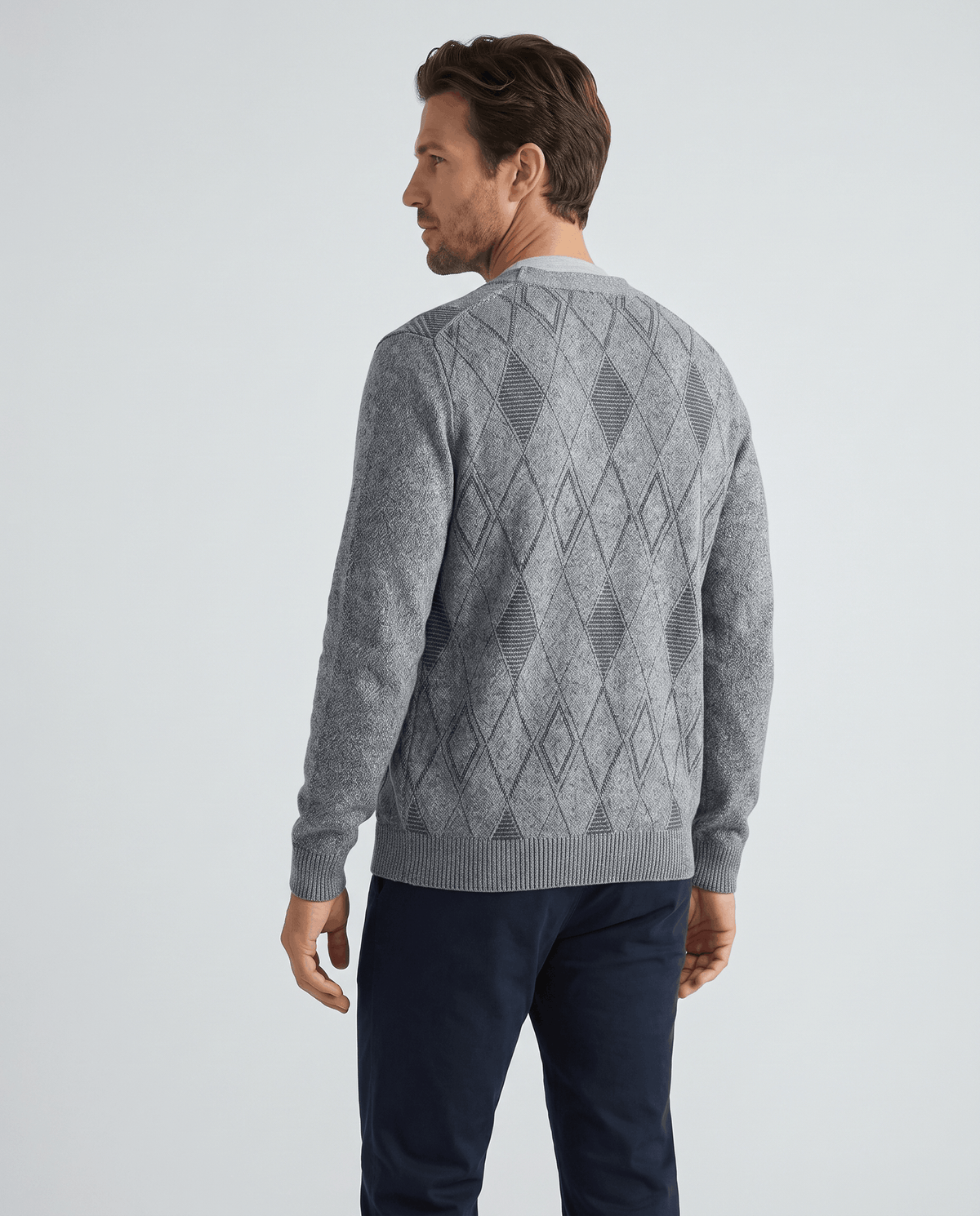 Back view of the light gray cardigan showing the diamond knit and ribbed cuffs