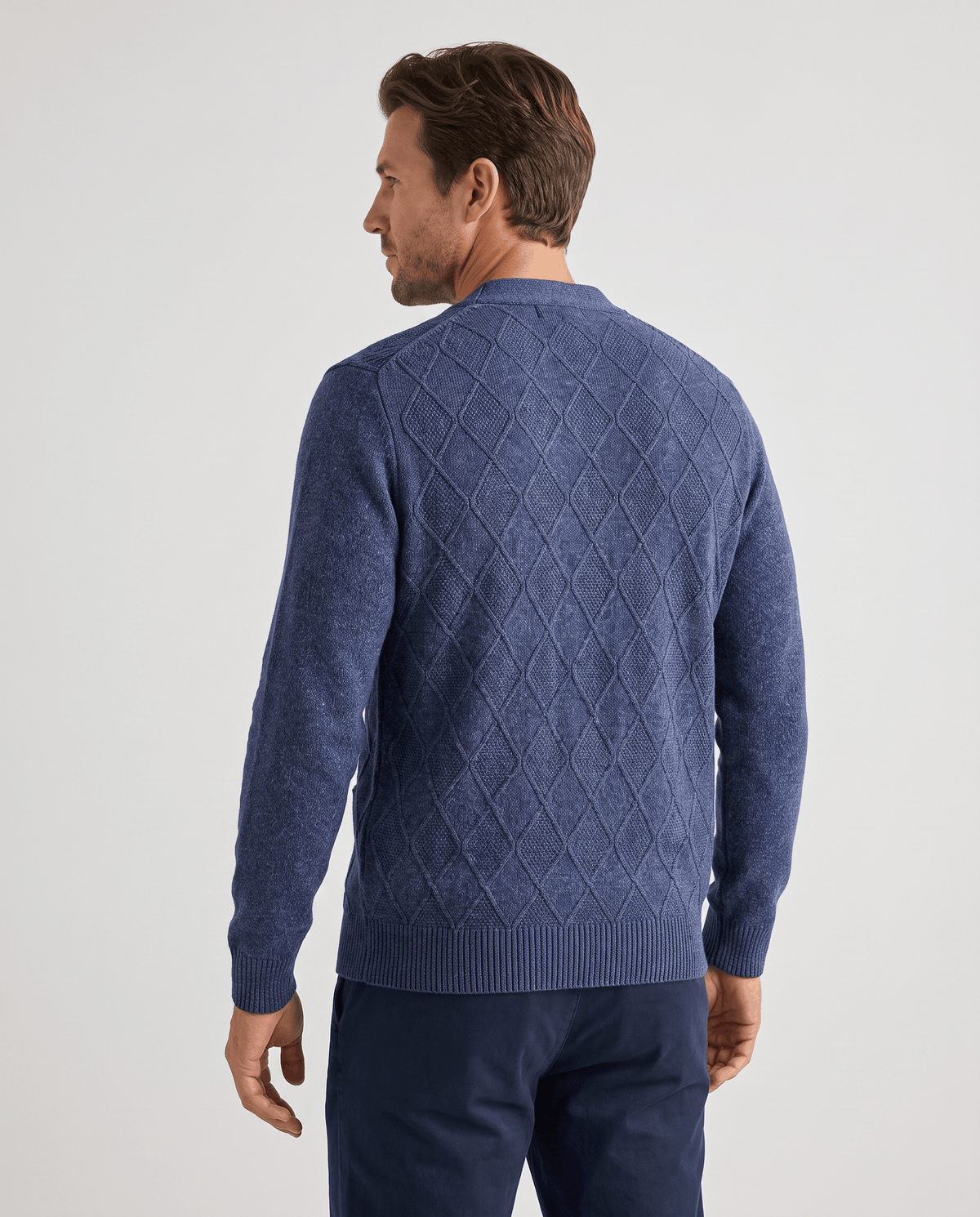 Back view of the navy cardigan with tonal diamond pattern and ribbed hem