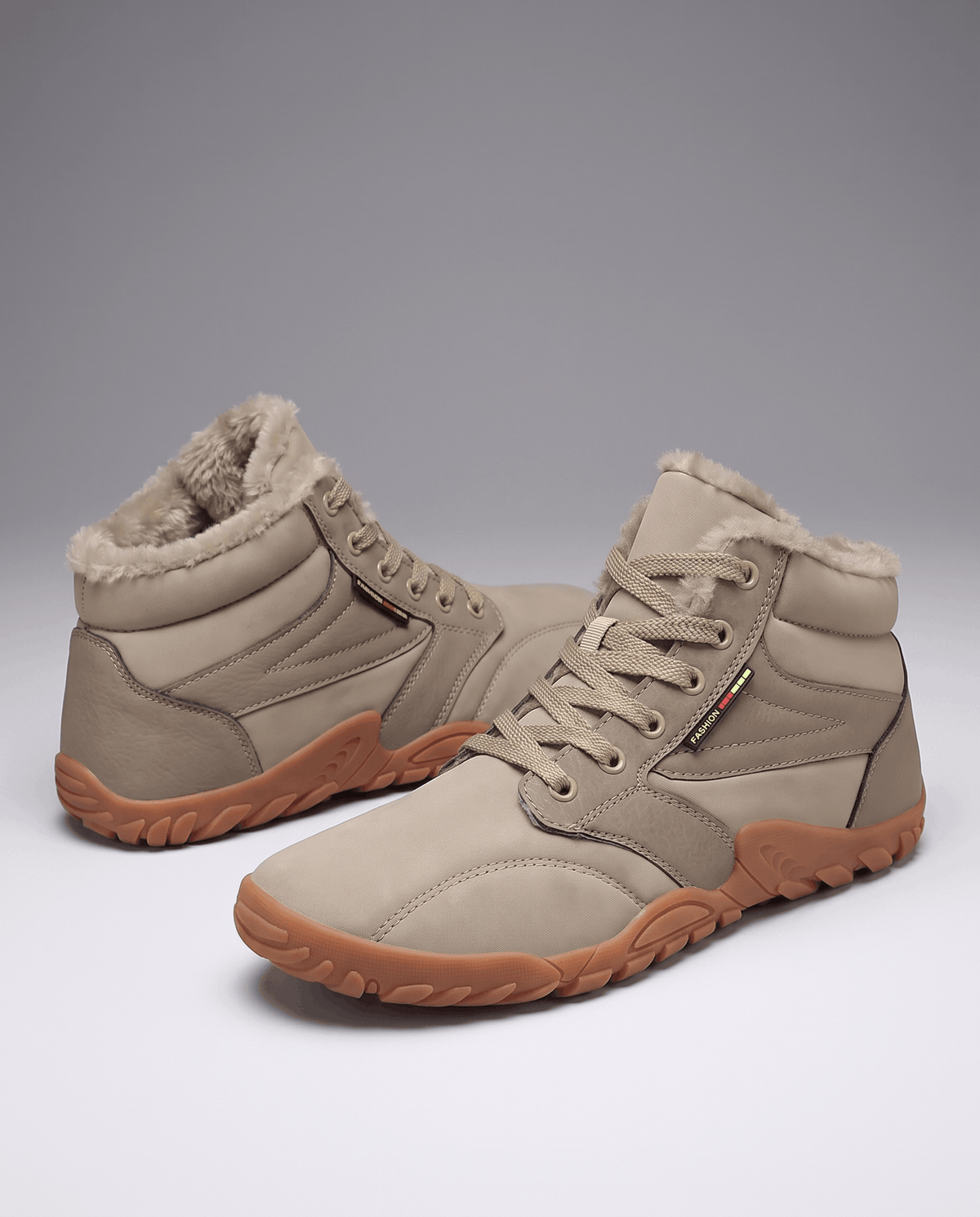 Sand beige boots straight on, laces threaded through reinforced metal eyelets