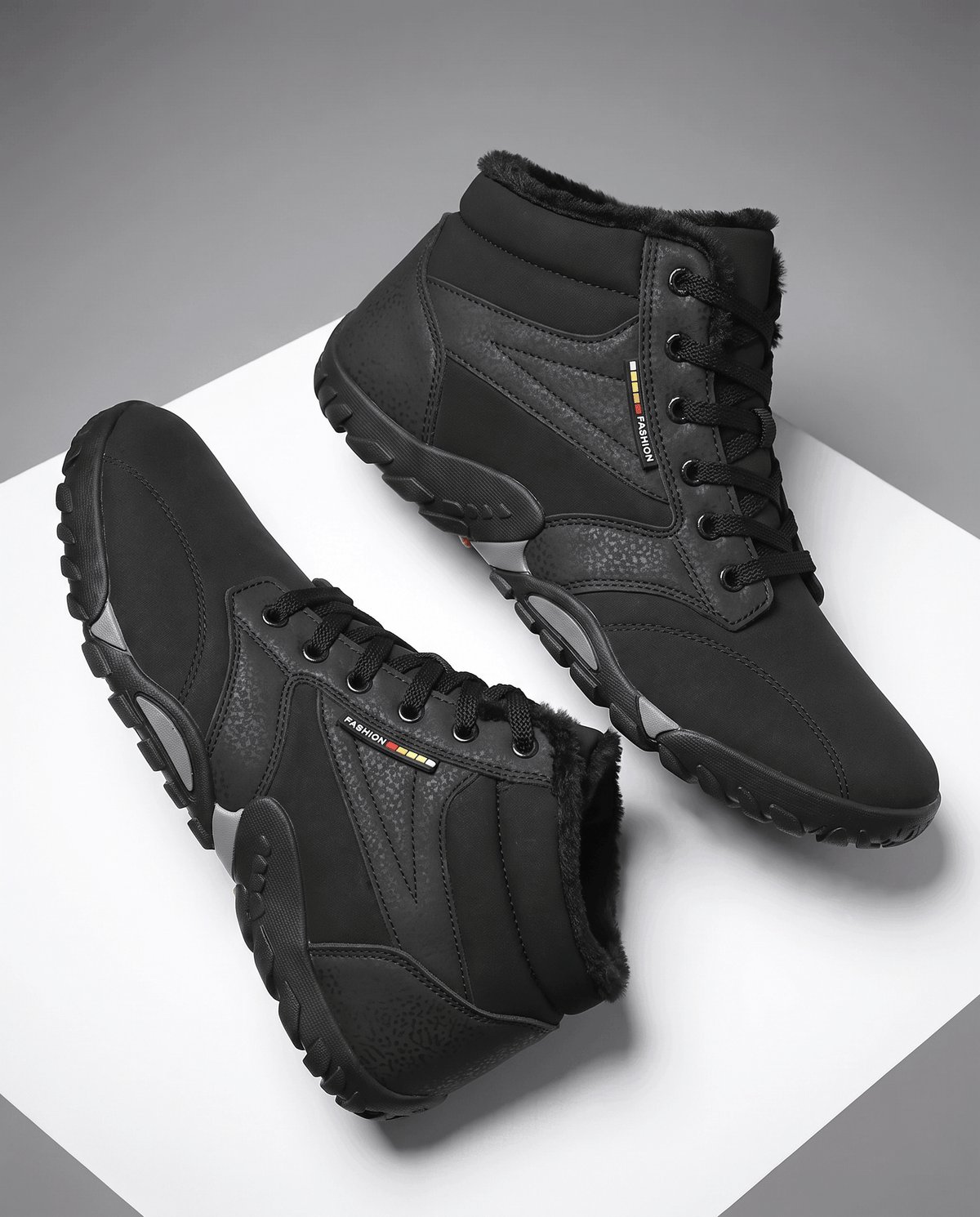 Pair of black brushed-upper ankle boots showing the low-profile sole from the side