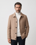 Man wearing the Henrik beige herringbone wool coat, buttoned front view