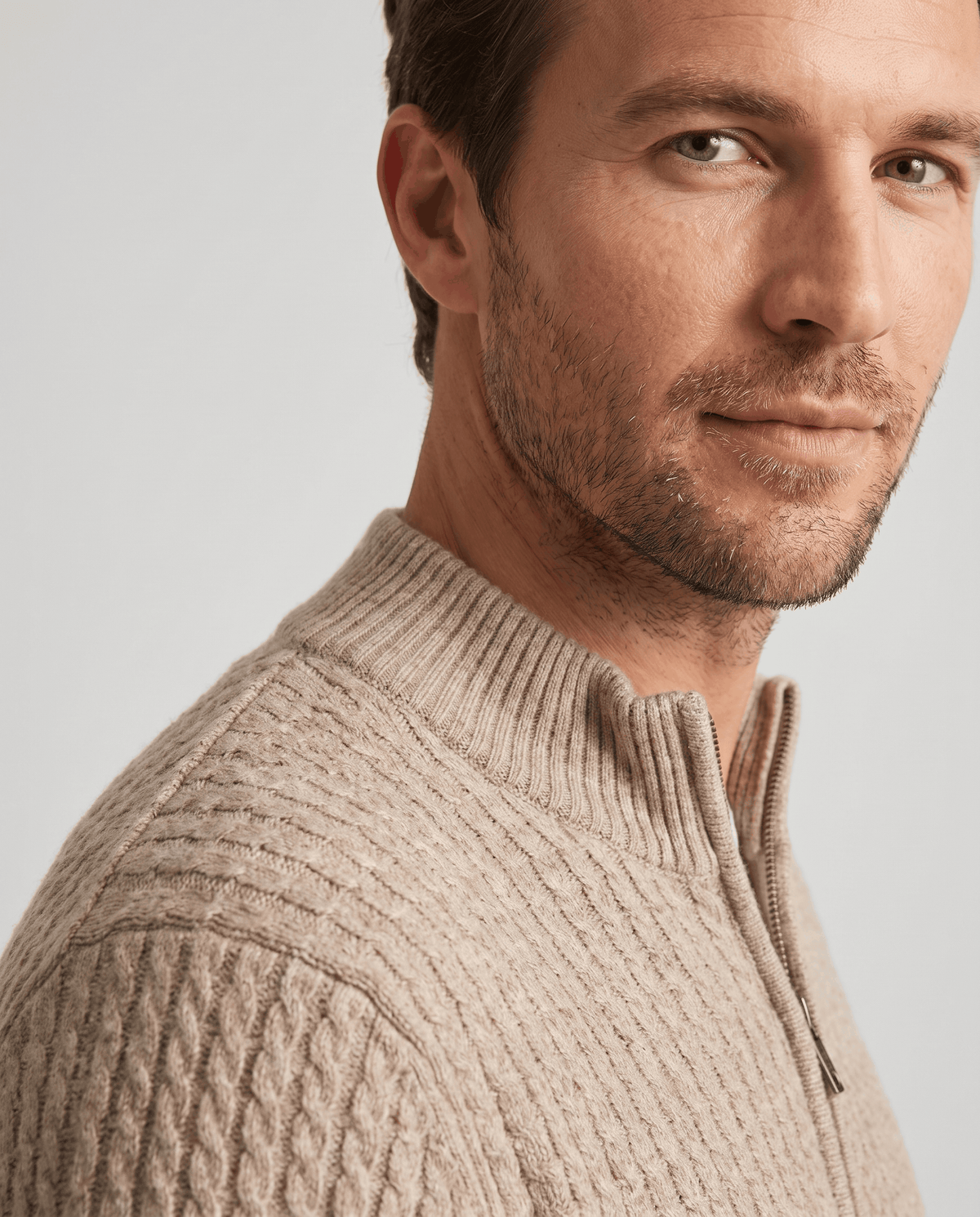 Close-up of the stand collar and zip on the Julian beige wool knit cardigan