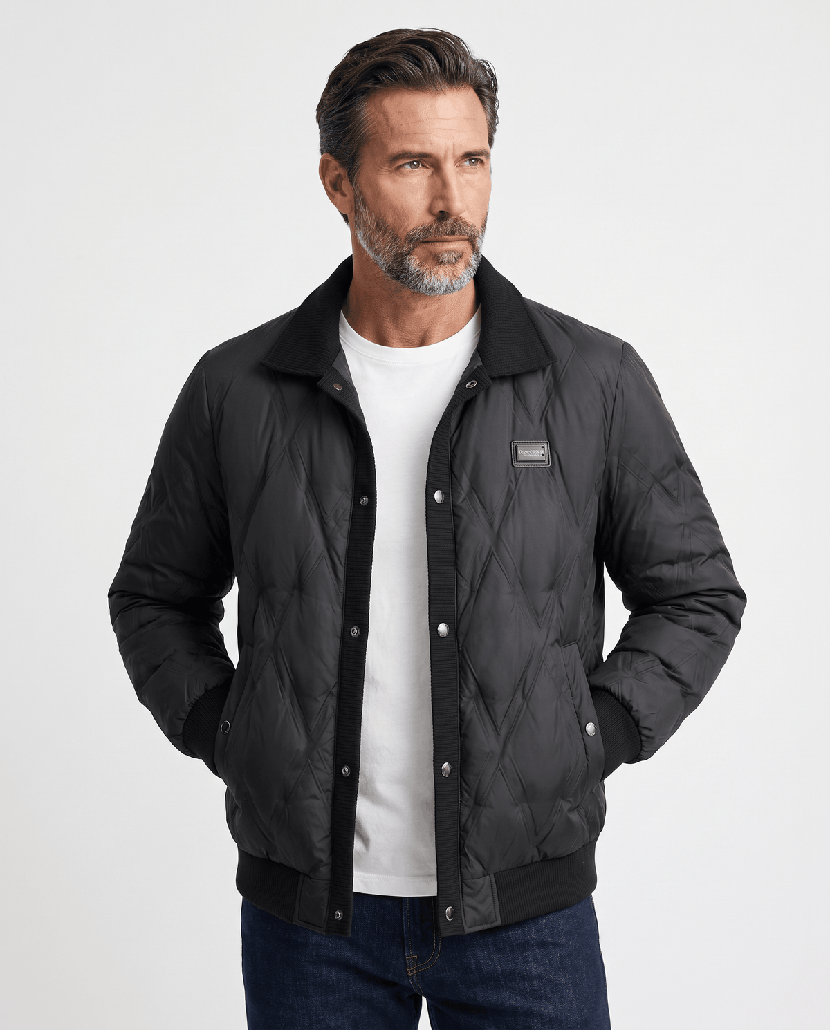 Man wearing a black diamond quilted duck down puffer jacket, front view