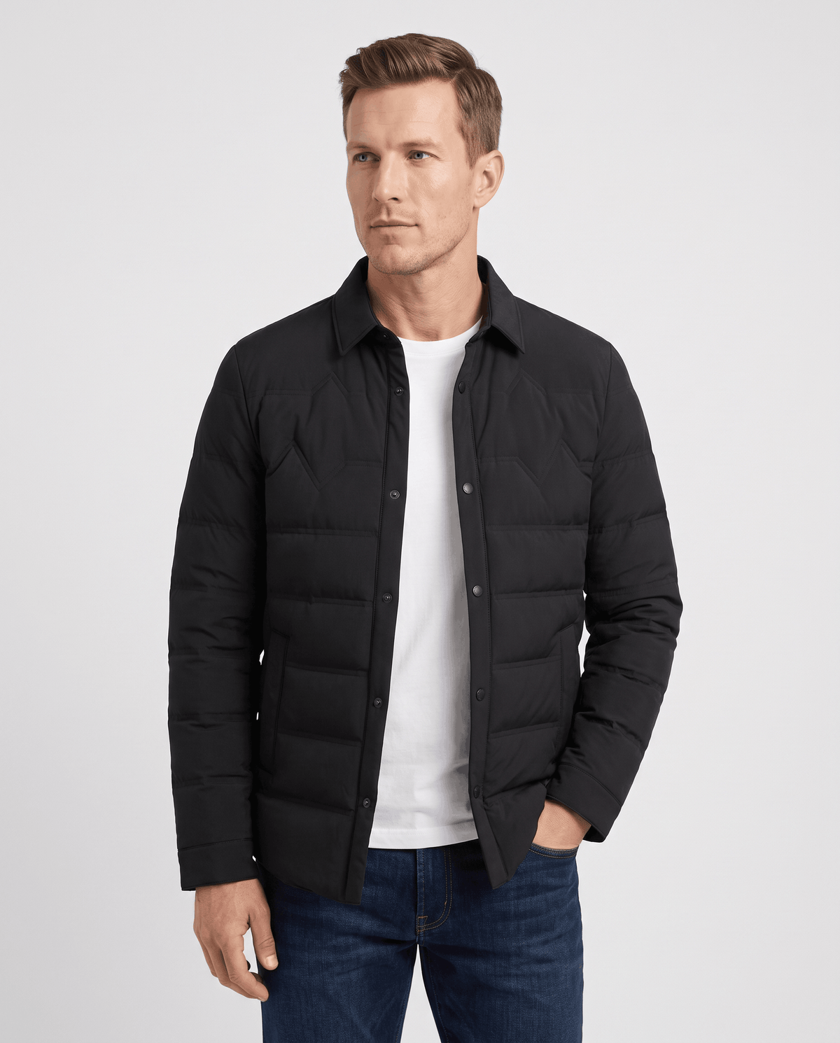Man wearing a black quilted duck down puffer jacket with snap front, front view