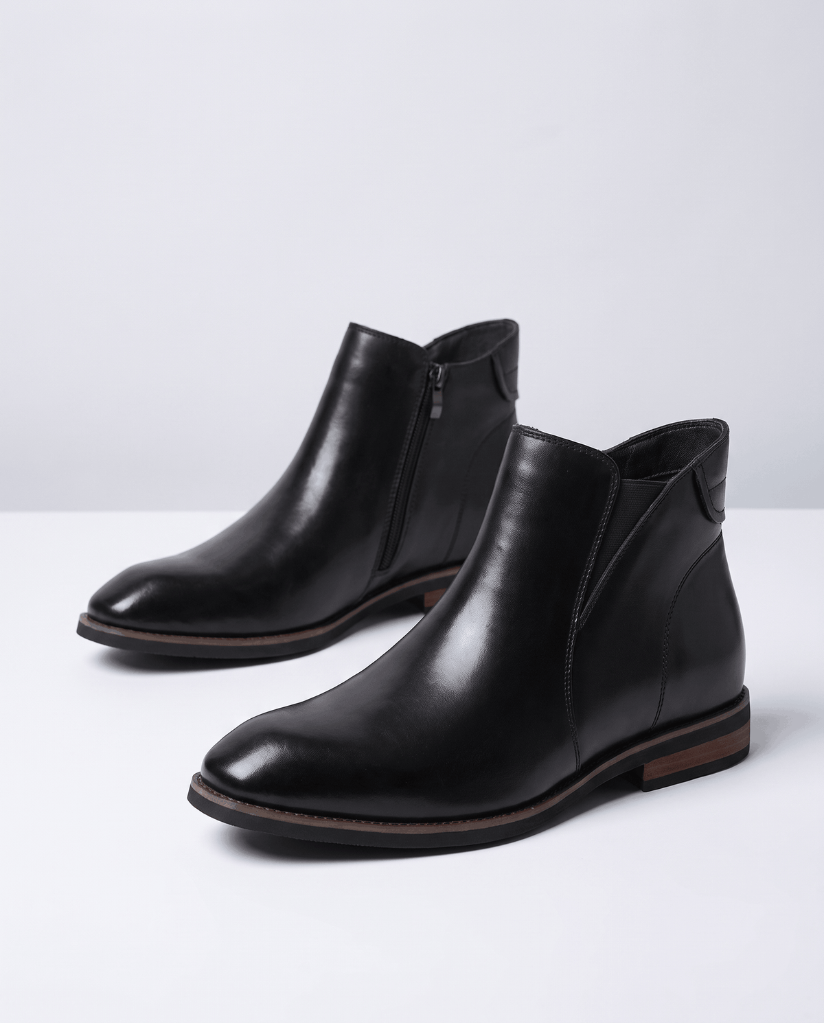 Black Chelsea boots with smooth upper and low stacked heel, side view