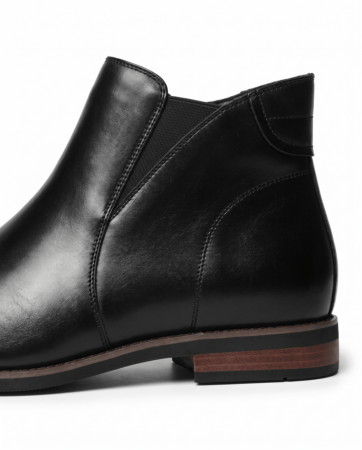 Side view of a black Chelsea boot showing the side zip and stacked heel
