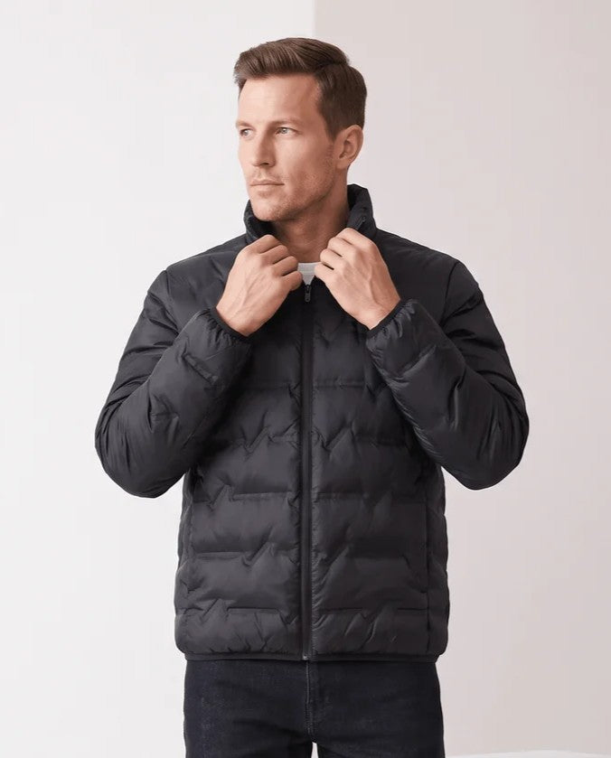 Man adjusting the stand collar of a black quilted duck down puffer jacket