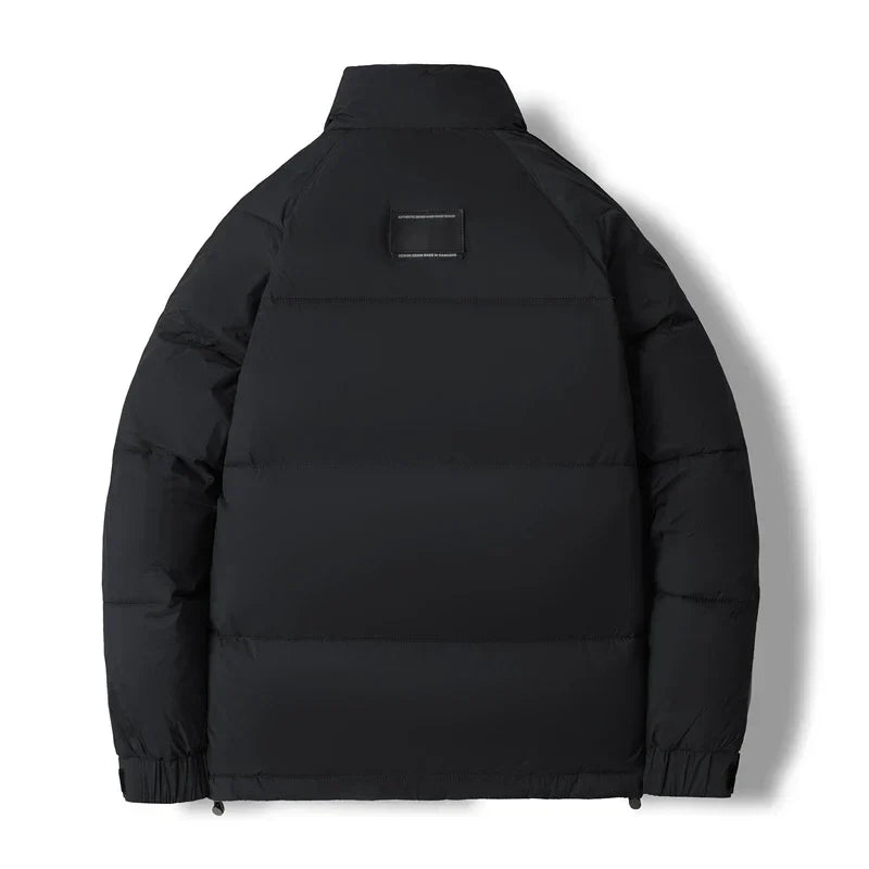 Black stand collar puffer jacket laid flat, back view