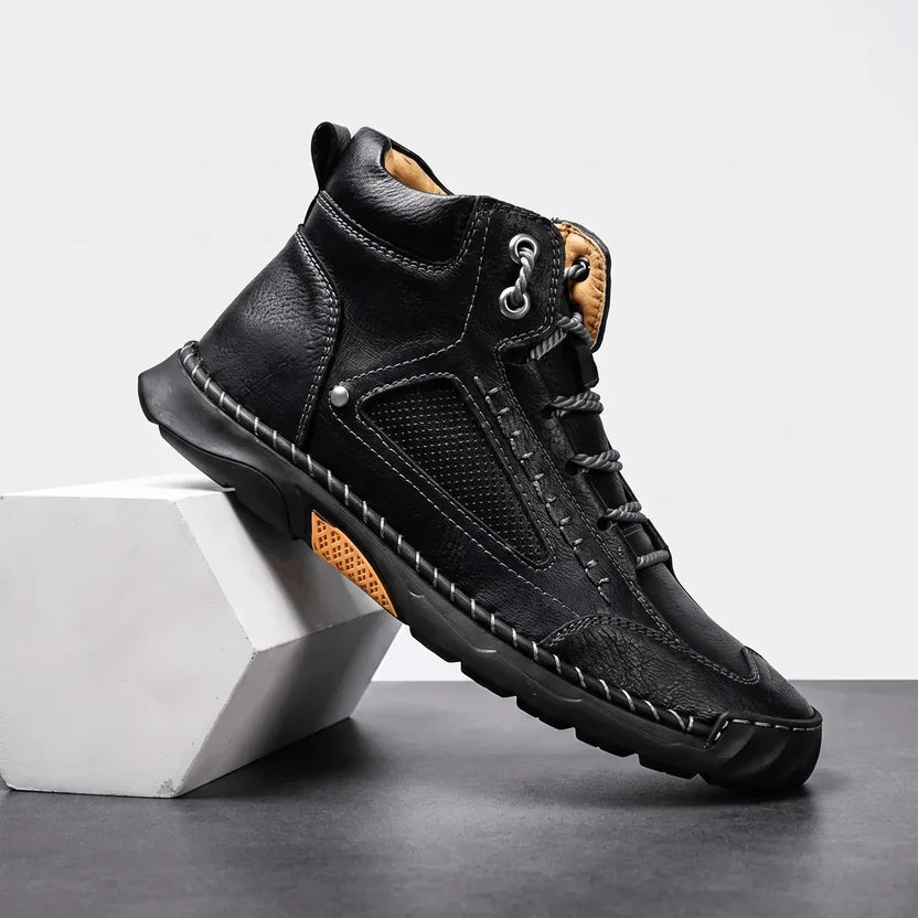 Black wide toe box hiking boot angled on a white block showing the lug sole