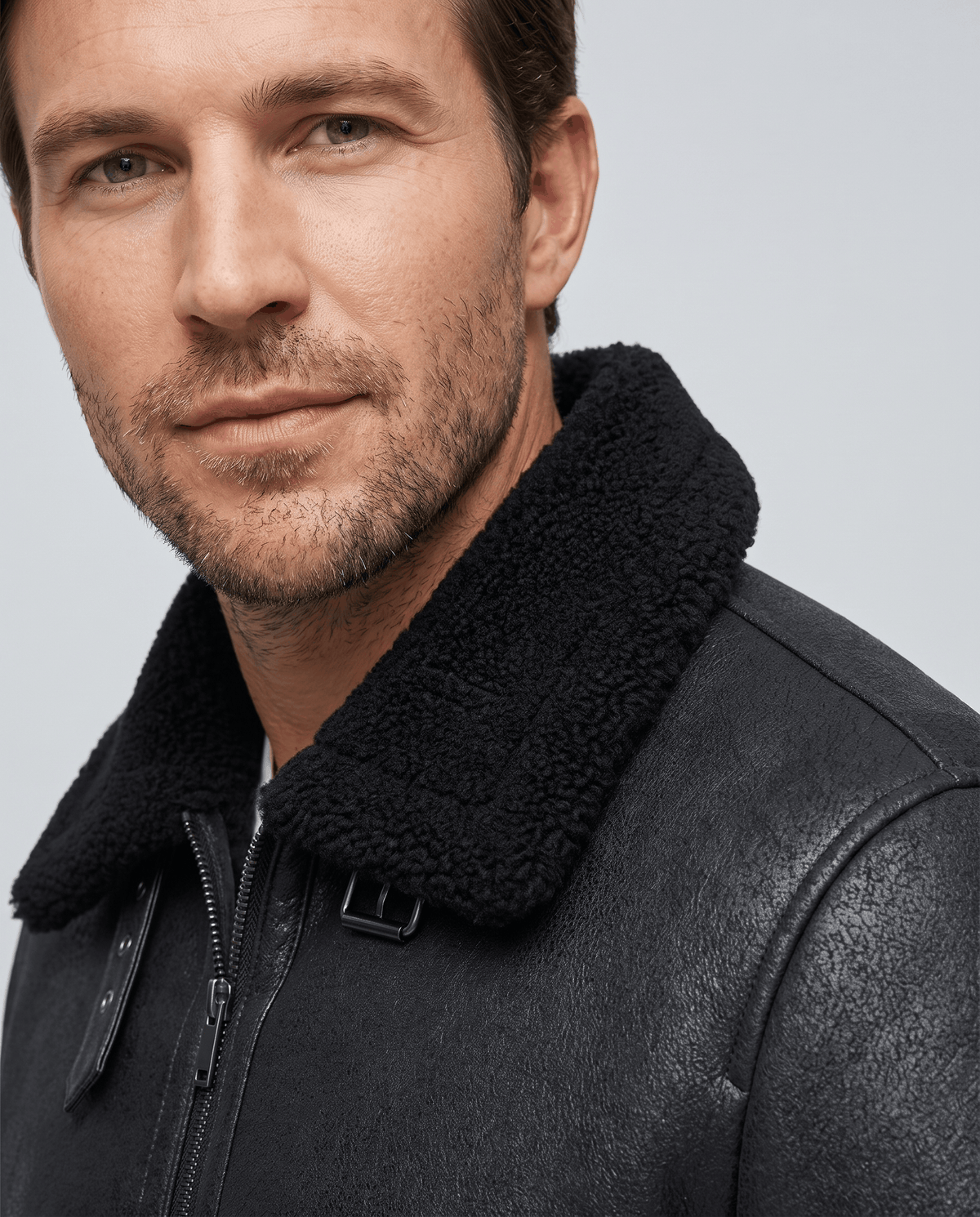 Close-up of the black sherpa collar on the Harlan vegan suede aviator jacket