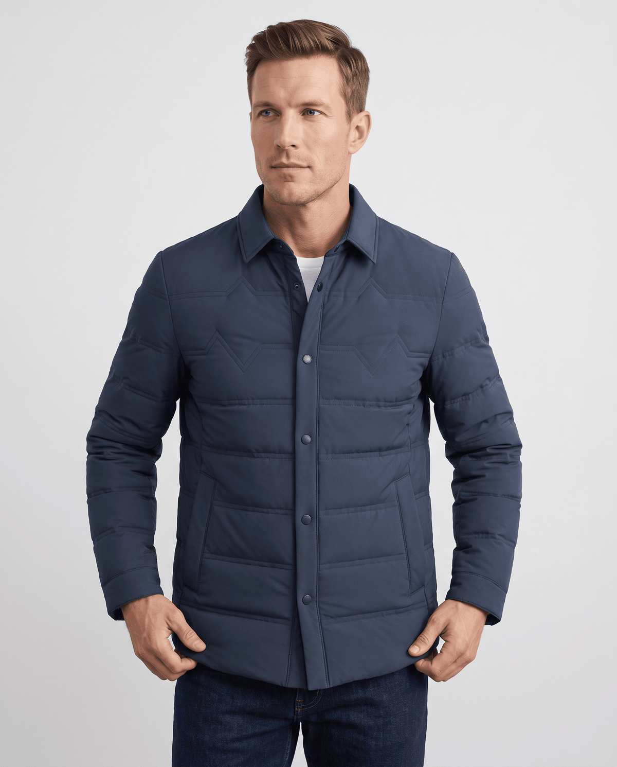 Man wearing a blue quilted duck down puffer jacket with snap front, front view