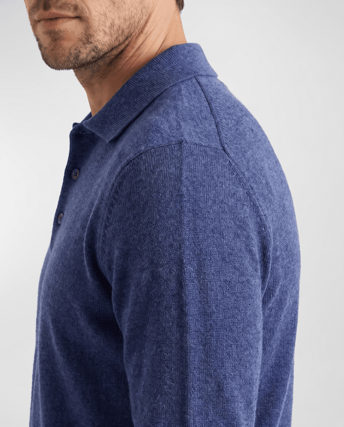 Side view of the collar and shoulder on the Elias blue wool knit polo sweater