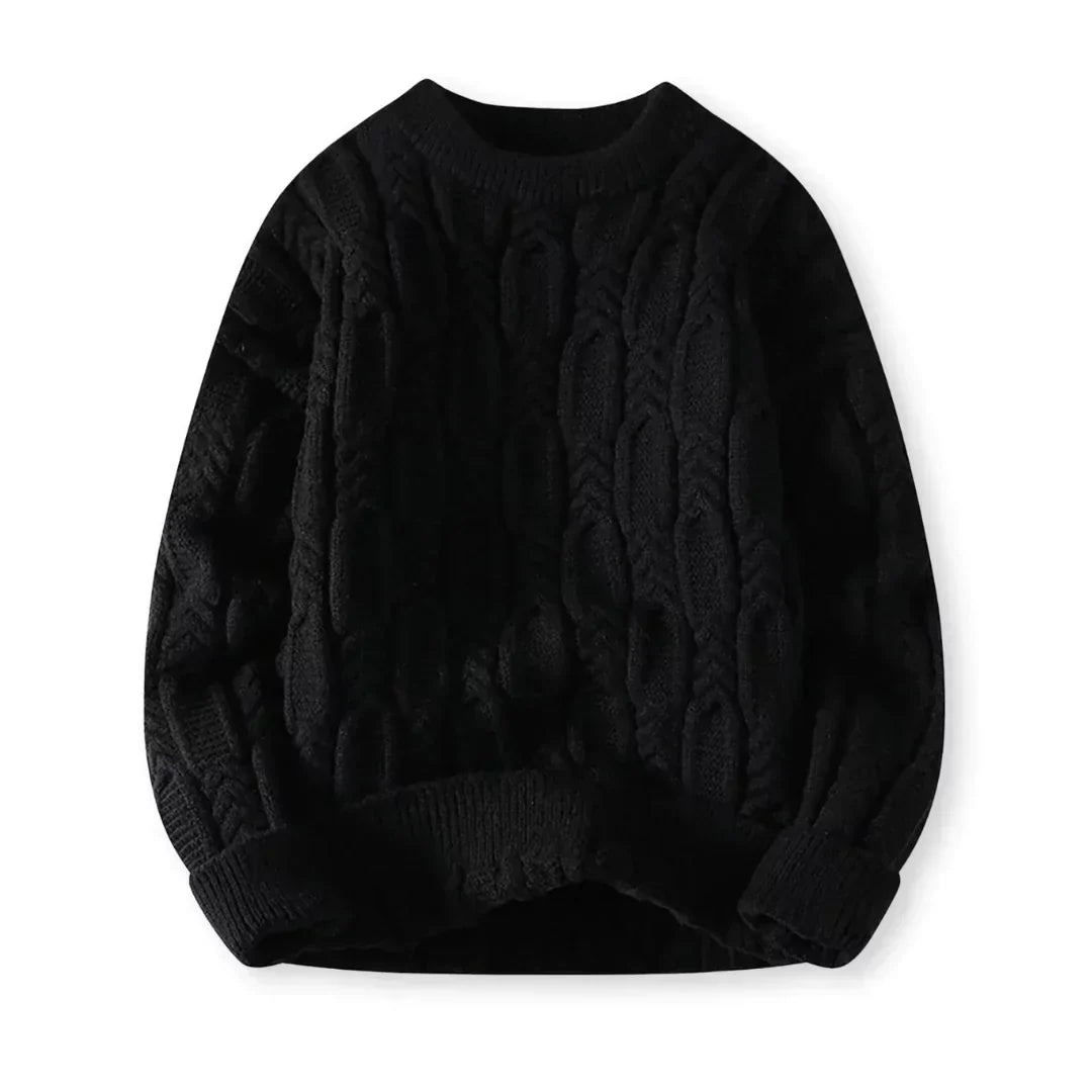 Flat-lay of black crew neck cable sweater on a white background