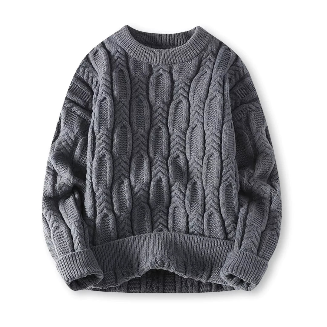 Flat-lay of charcoal gray crew neck cable sweater on a white background