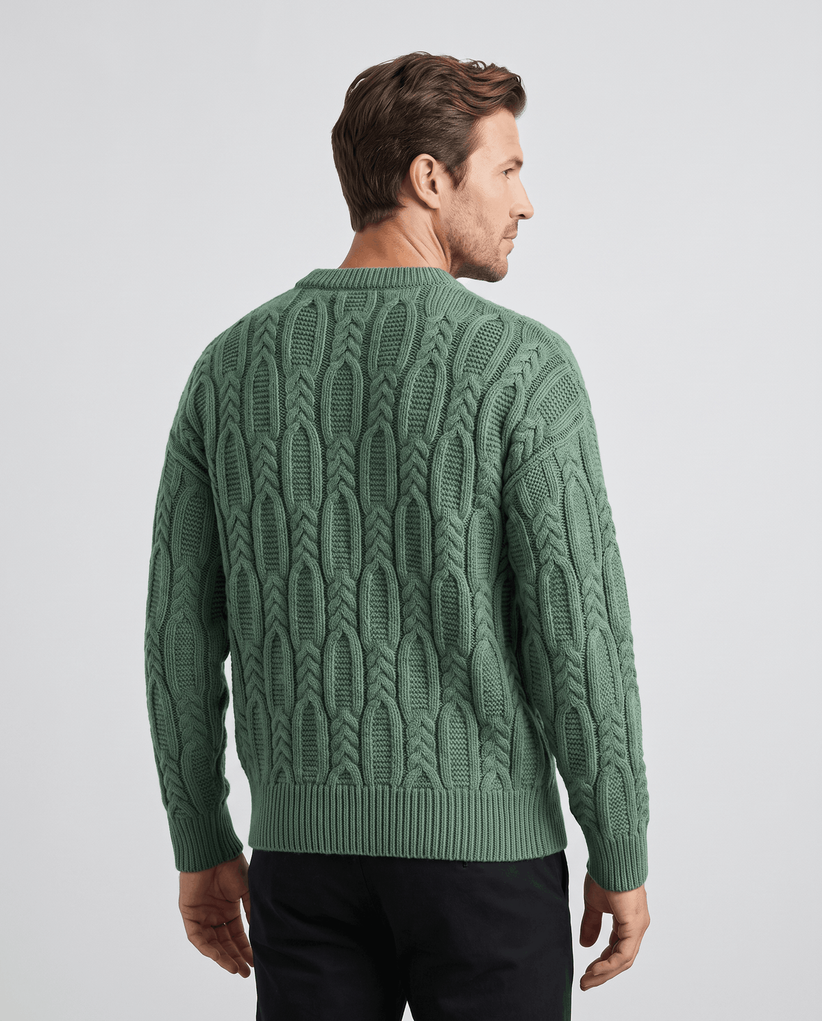 Back view of green cable pullover with ribbed hem and cuffs