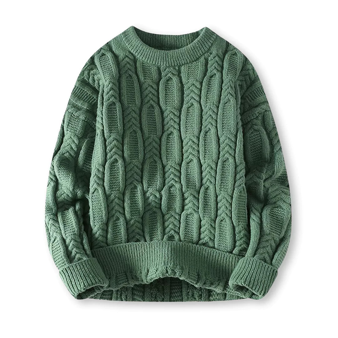 Flat-lay of green crew neck cable sweater on a white background