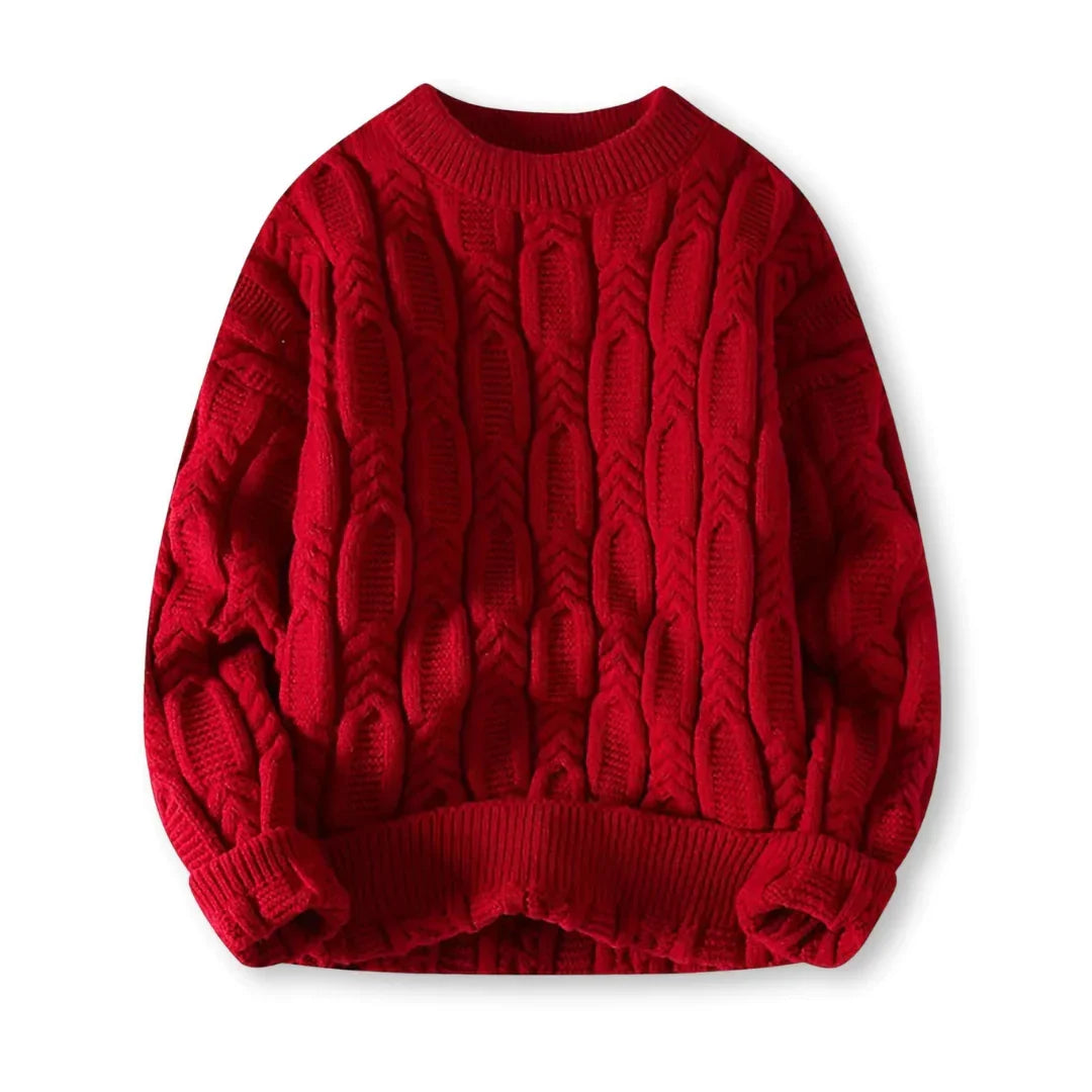 Flat-lay of red braided cable sweater on a white background