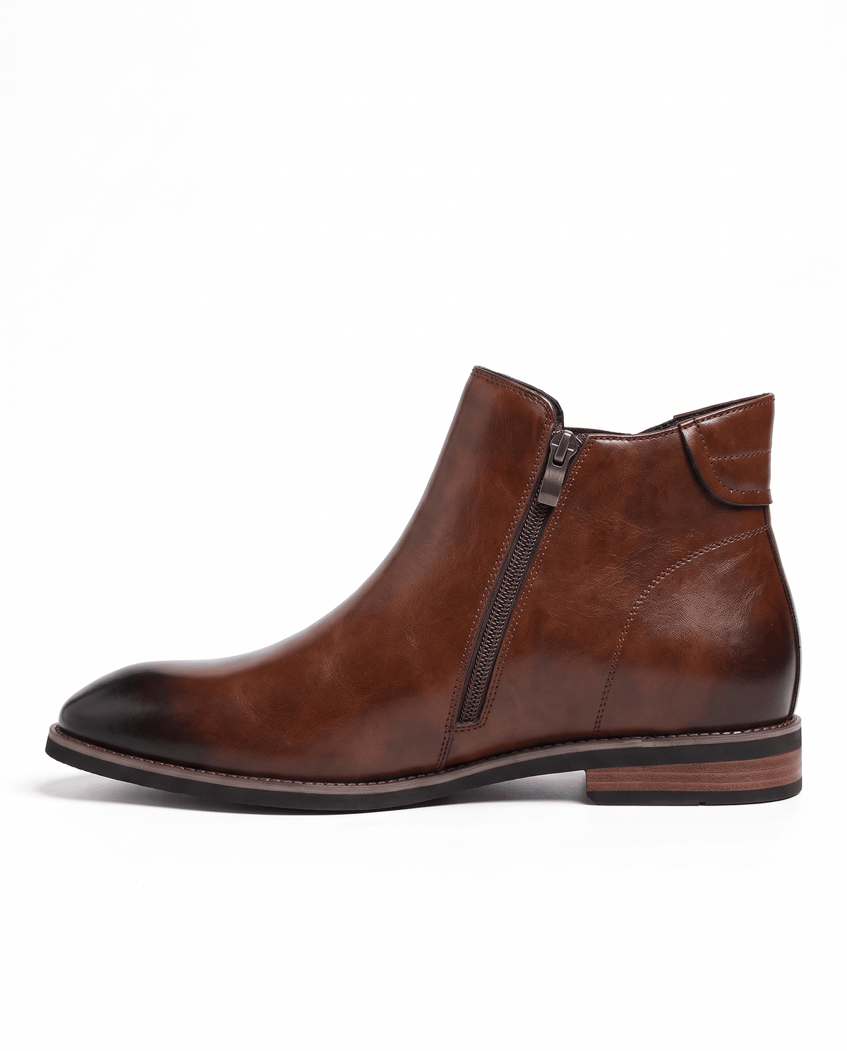 Side view of a brown Chelsea boot showing the side zip and low stacked heel
