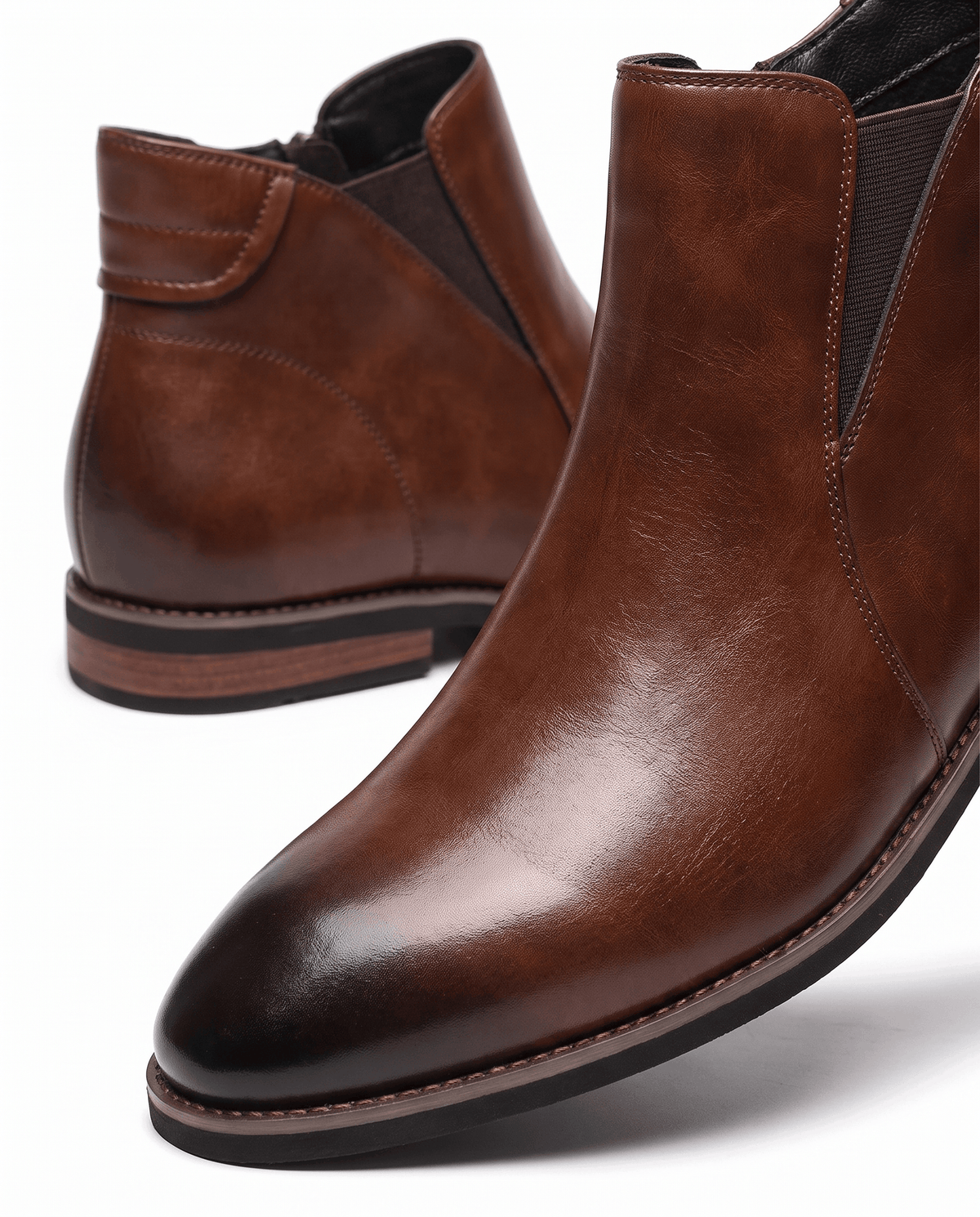Close-up of the darkened toe cap on brown Chelsea boots