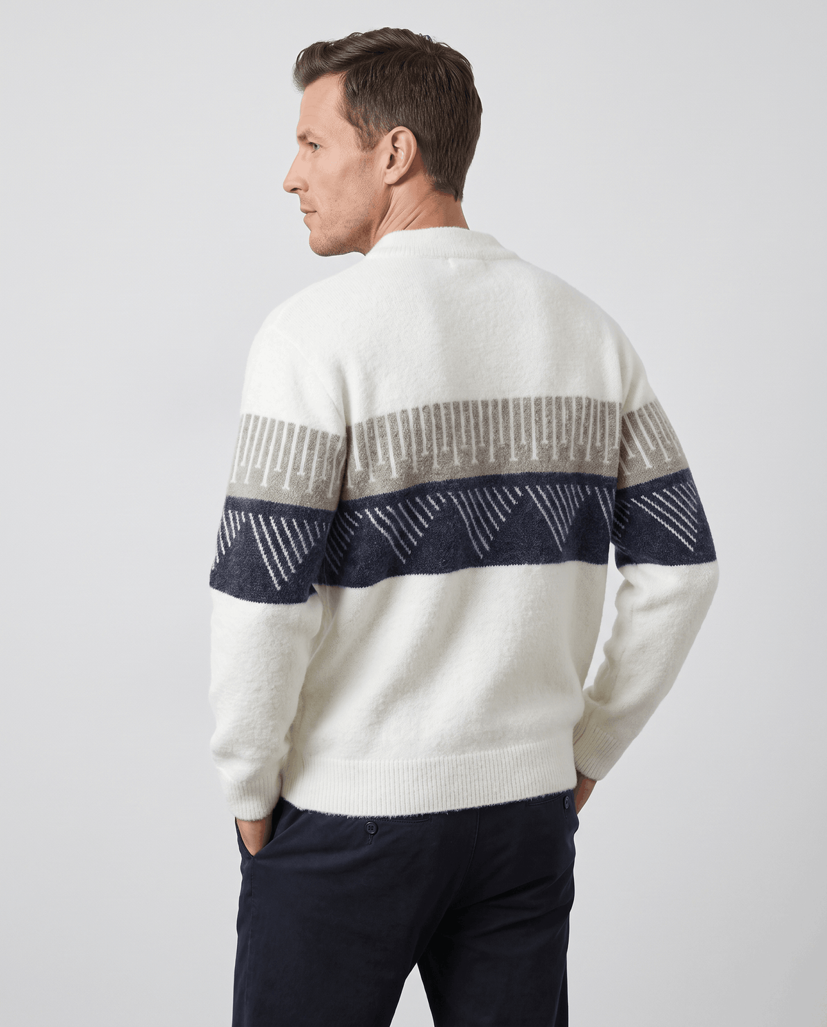 Back view of white knit sweater showing the geometric band around the sleeves
