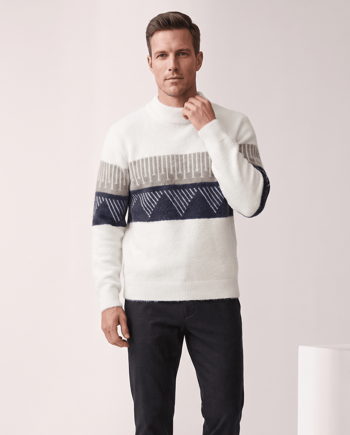 Man wearing men's brushed knit crew neck sweater in white with a navy chest band