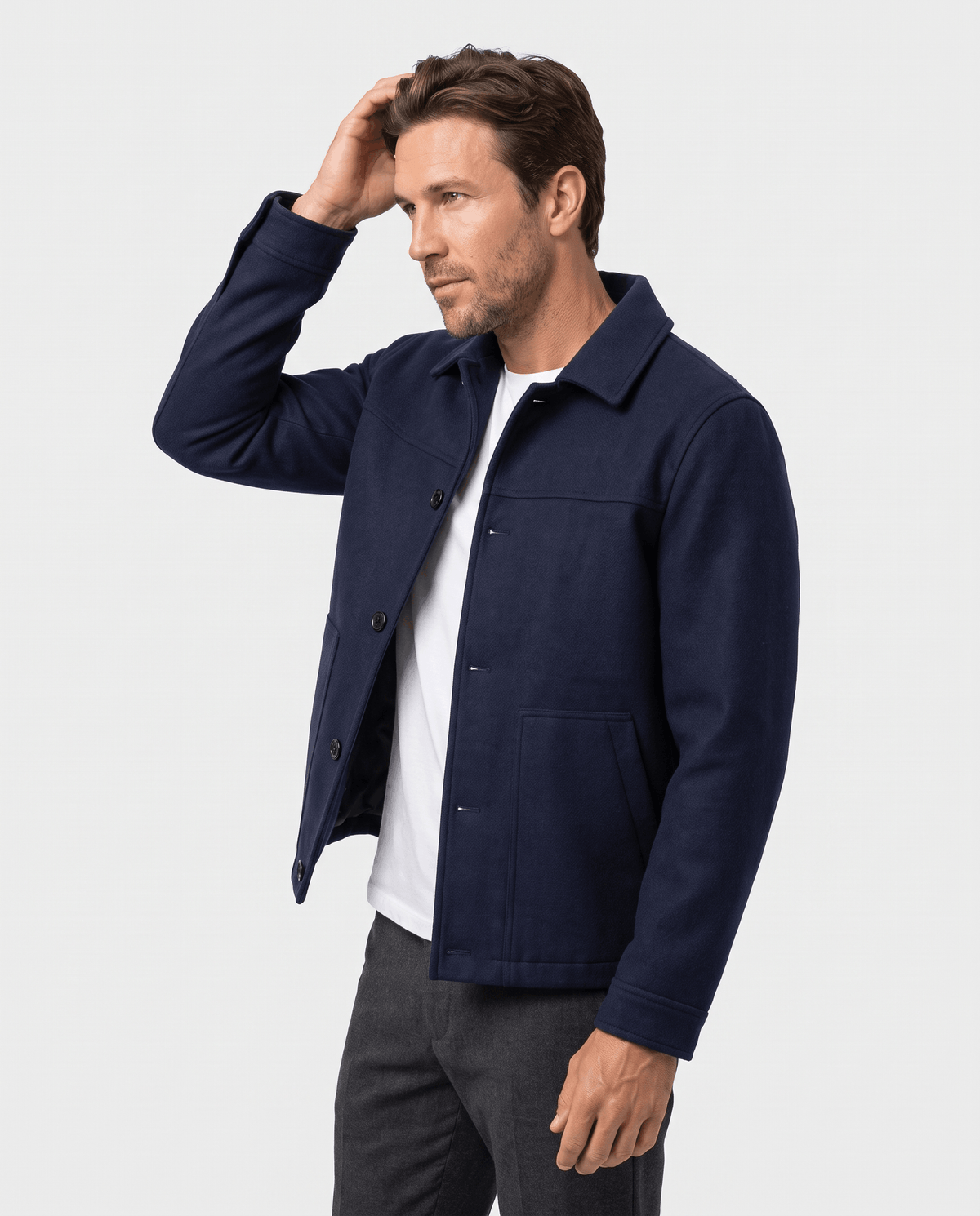 Model adjusting the navy jacket, placket open down the front