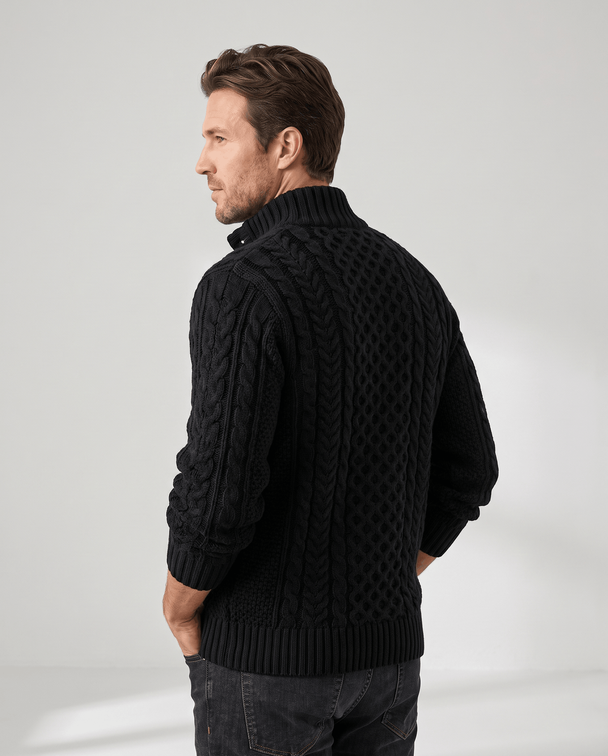 Three-quarter back view of black cable pullover with ribbed collar