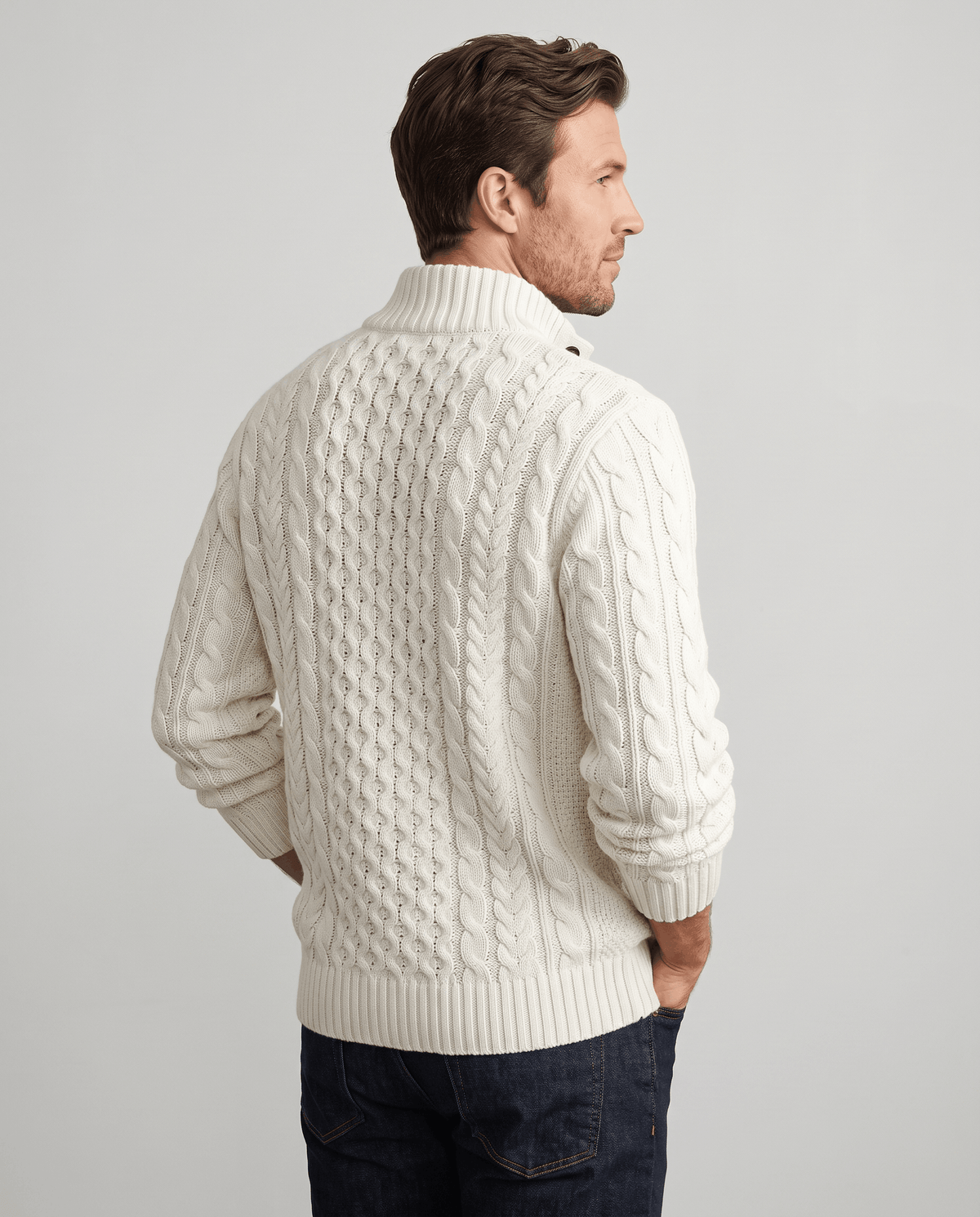 Back view of cream cable sweater with ribbed stand collar
