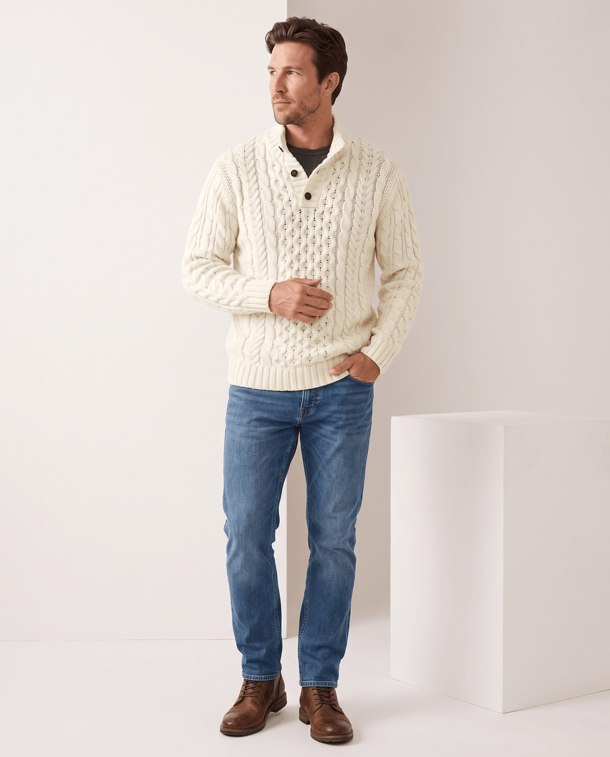 Full-length cream cable sweater outfit with jeans and brown boots