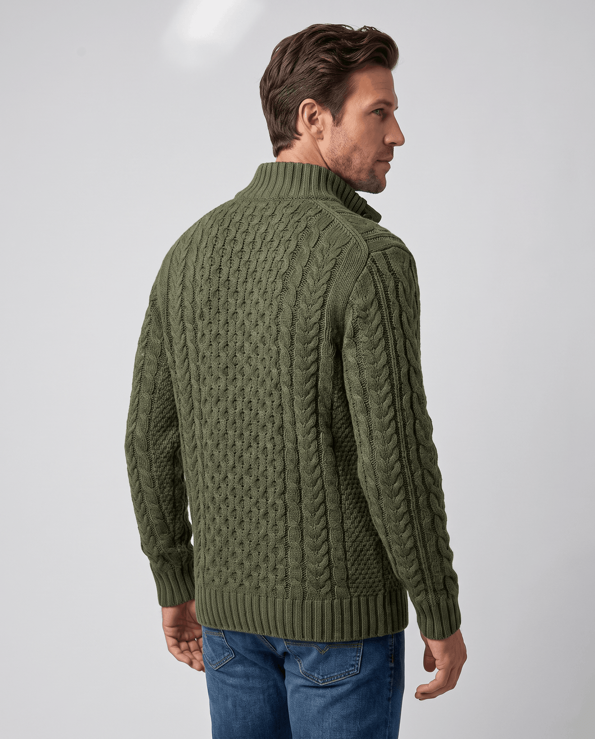 Back view of dark green cable pullover with ribbed hem