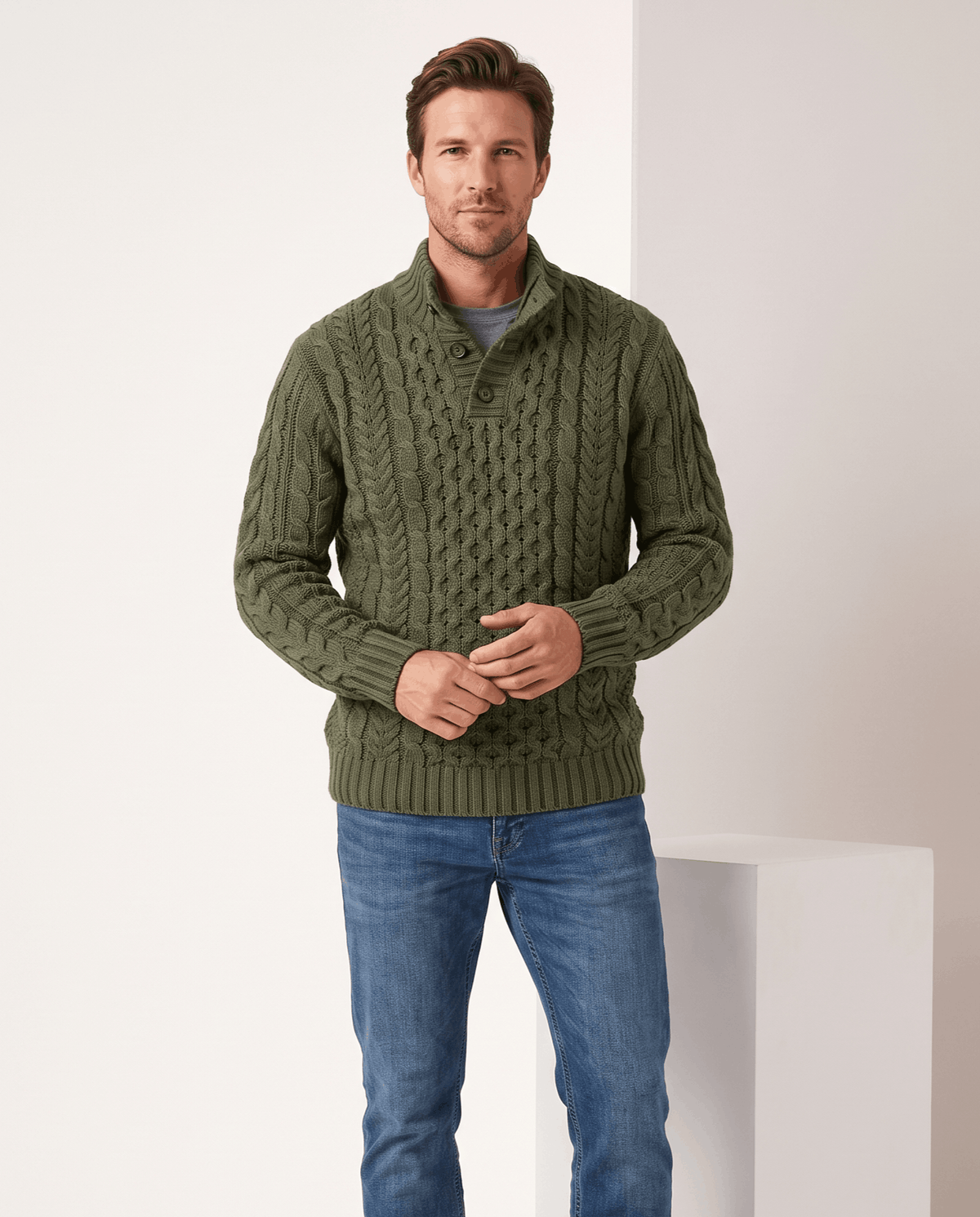 Model in dark green button neck cable sweater with blue jeans