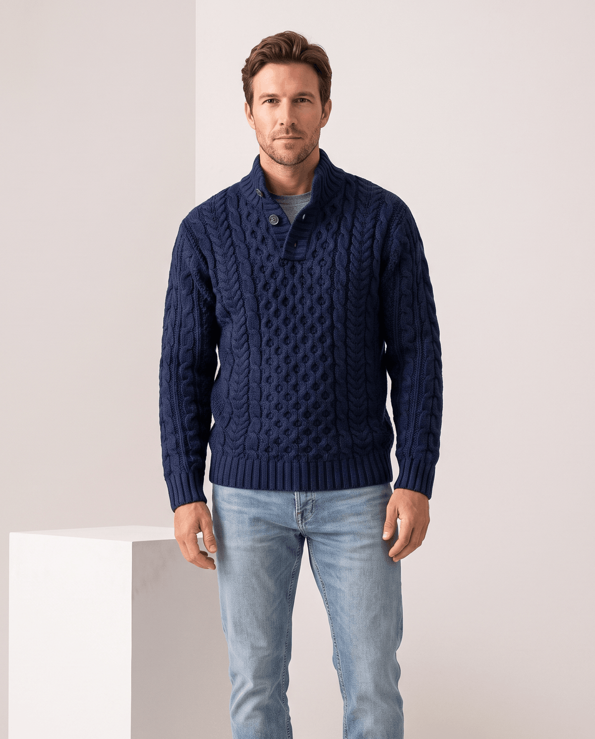 Model in navy button mock neck sweater with light jeans