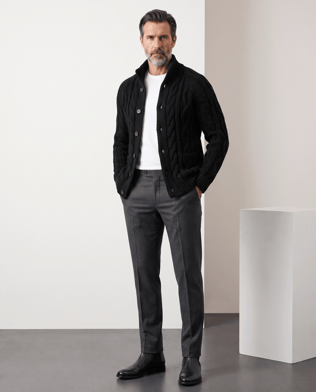 Full-length look with black cardigan, gray trousers and black boots
