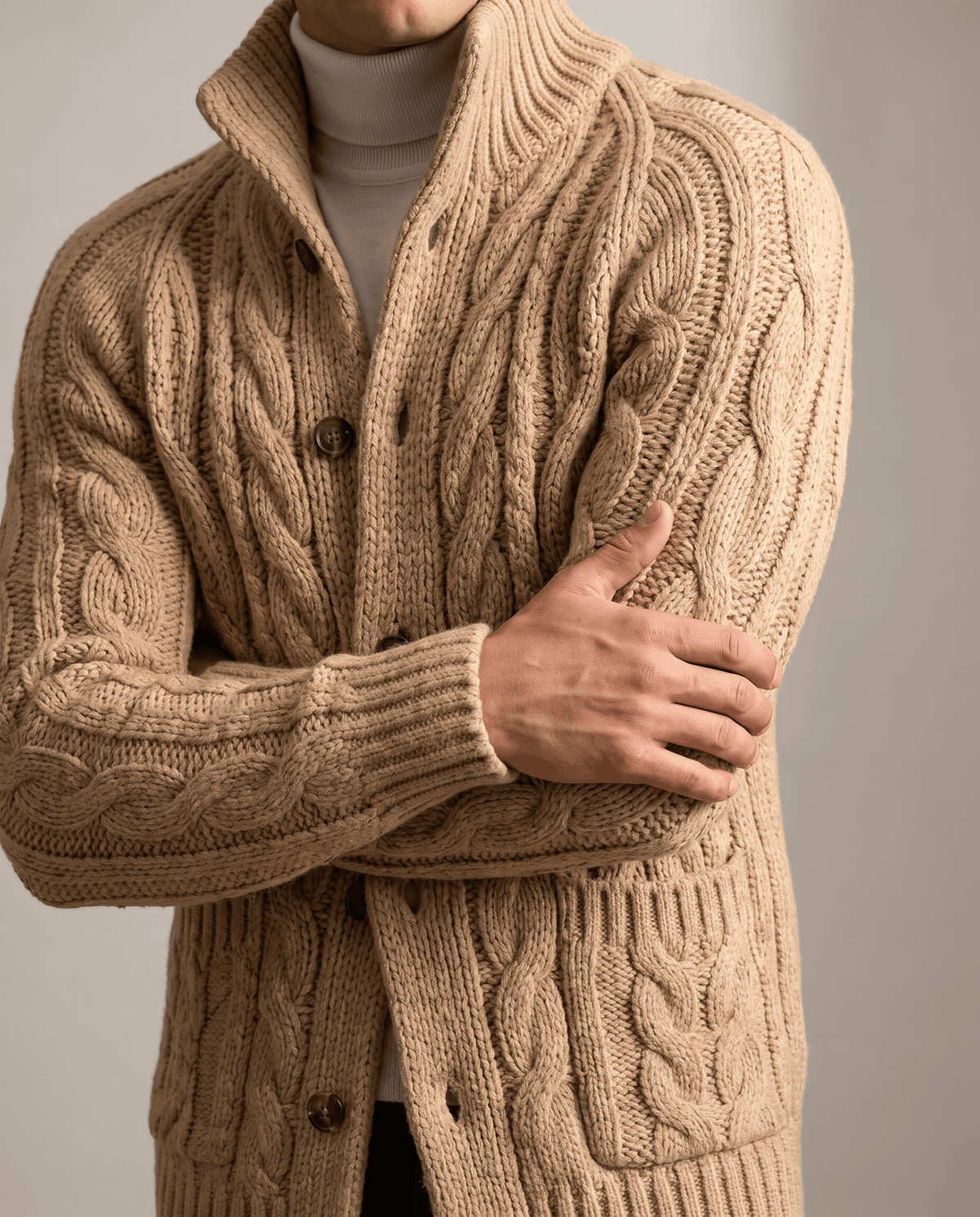 Light brown cable knit cardigan buttons and chunky cables shown in close view
