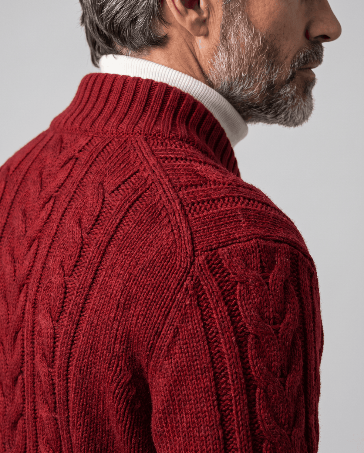 Close back view of red cable knit cardigan collar and shoulder